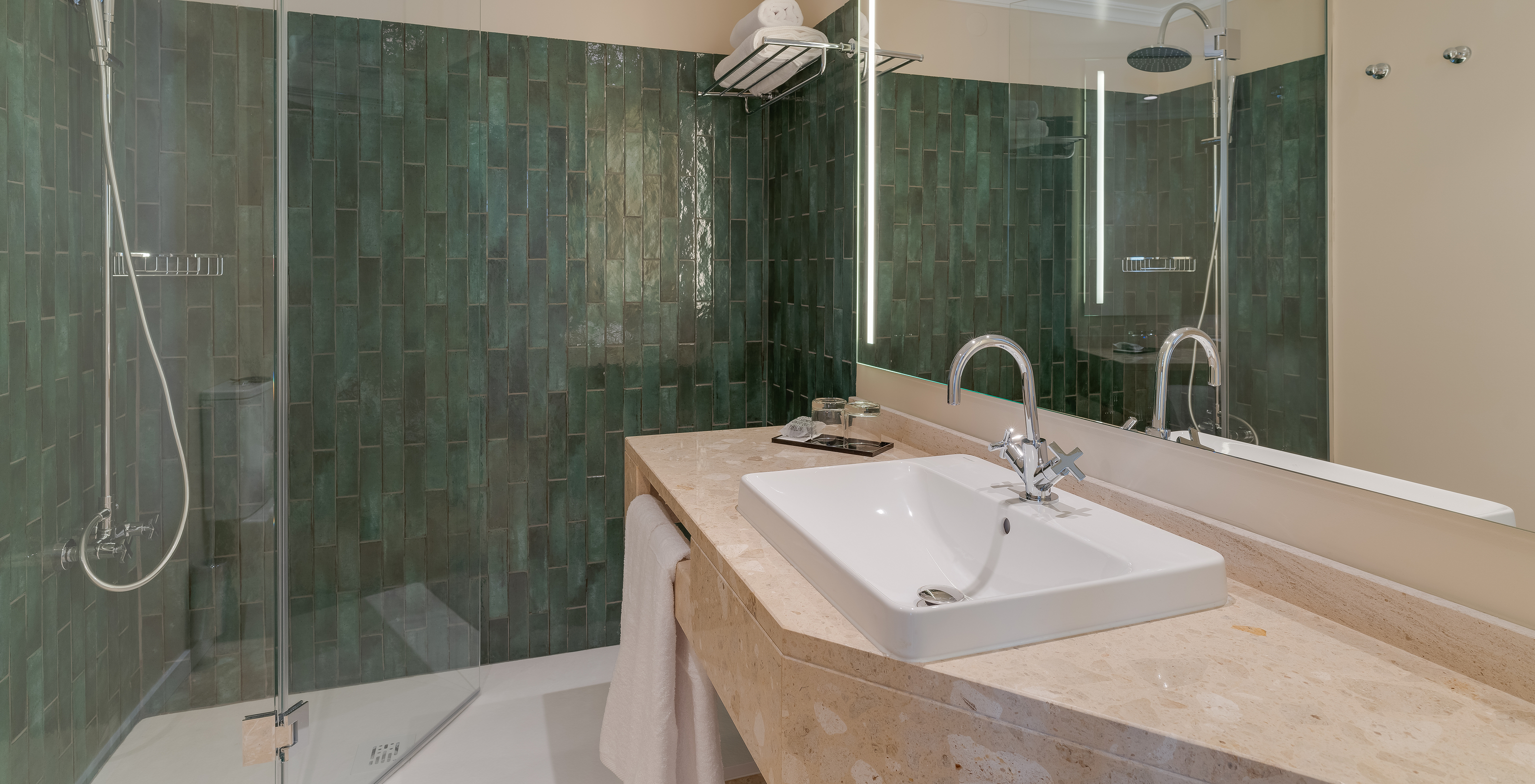 Junior Suite at Pestana Quinta Perestrello has a bathroom with sink, mirror, towels, and shower