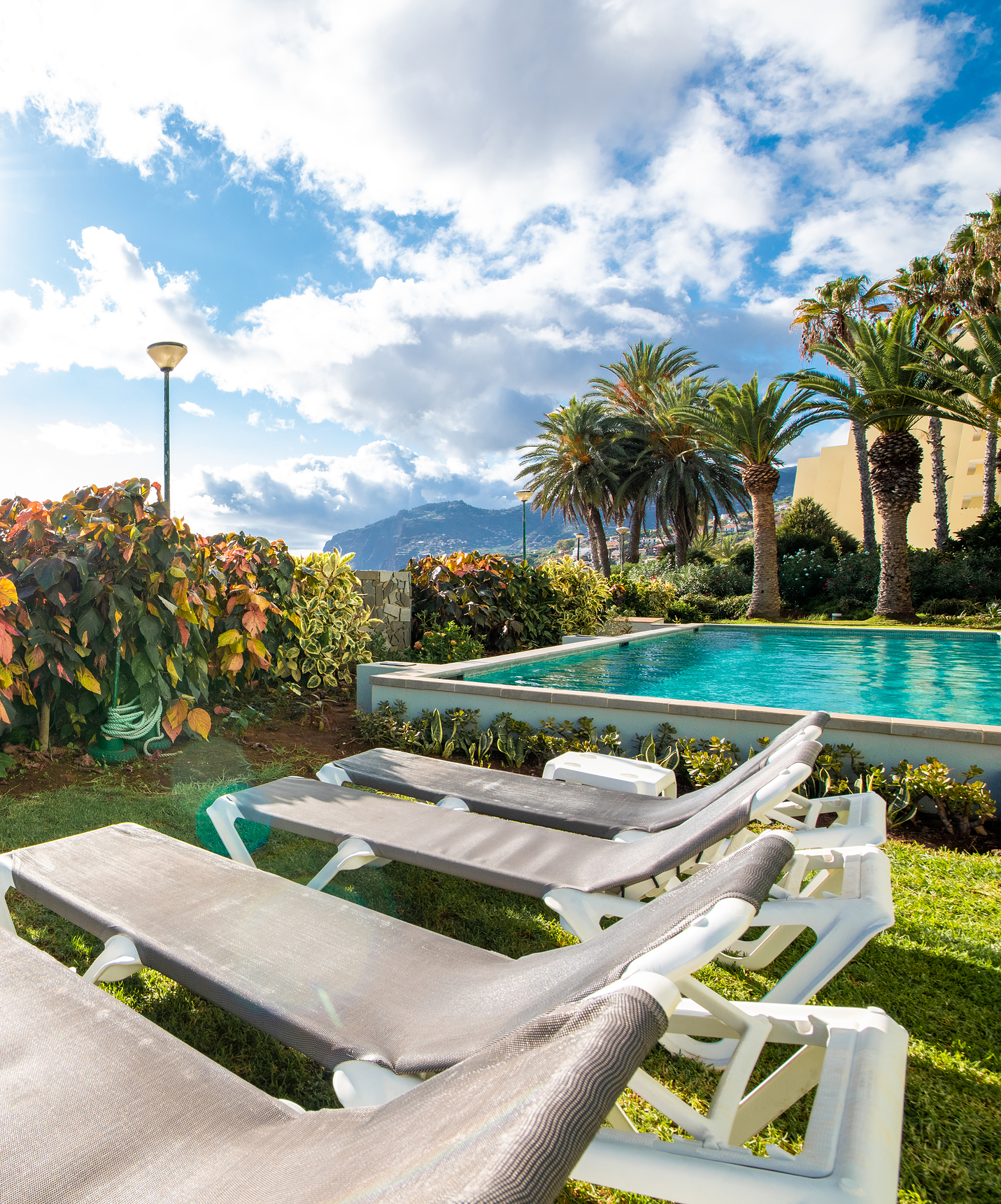 Pool loungers at Pestana Ocean Bay All Inclusive, all-inclusive hotel facing the sea, with a pool