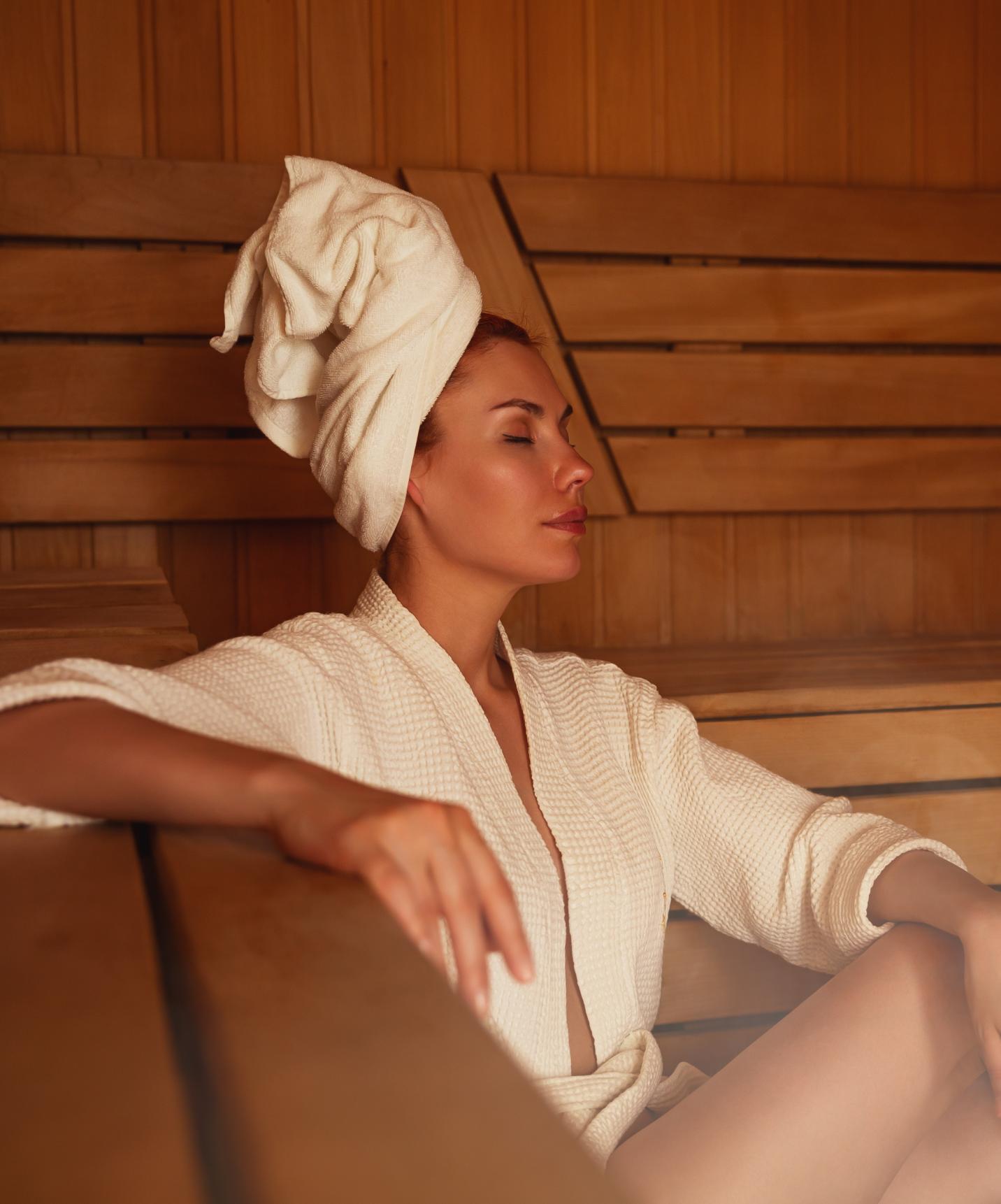 Lady relaxing in the sauna at Pestana Ocean Bay All Inclusive Hotel facing the sea with pool