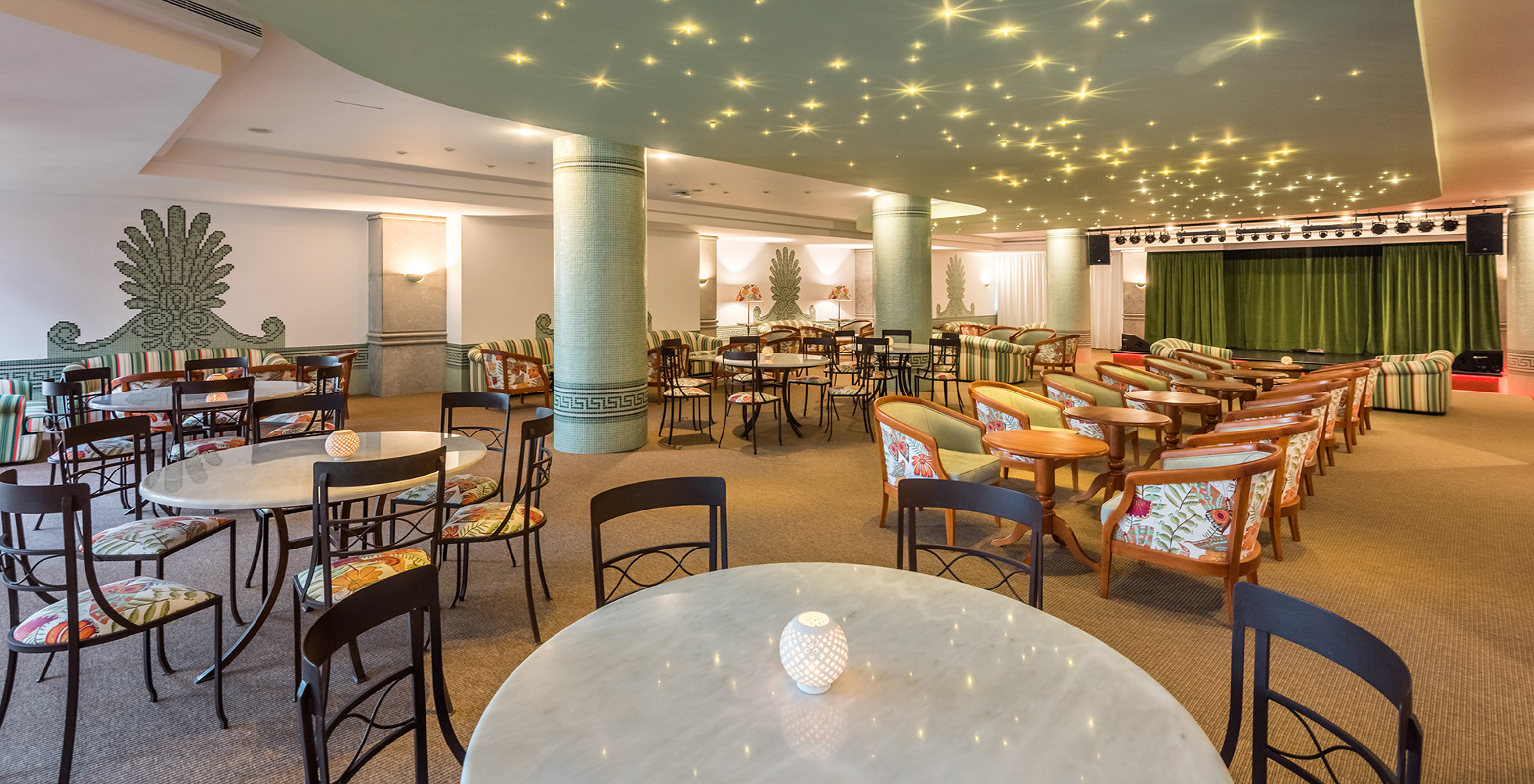 Pestana Royal All Inclusive, hotel near the beach, has an entertainment area with chairs and tables