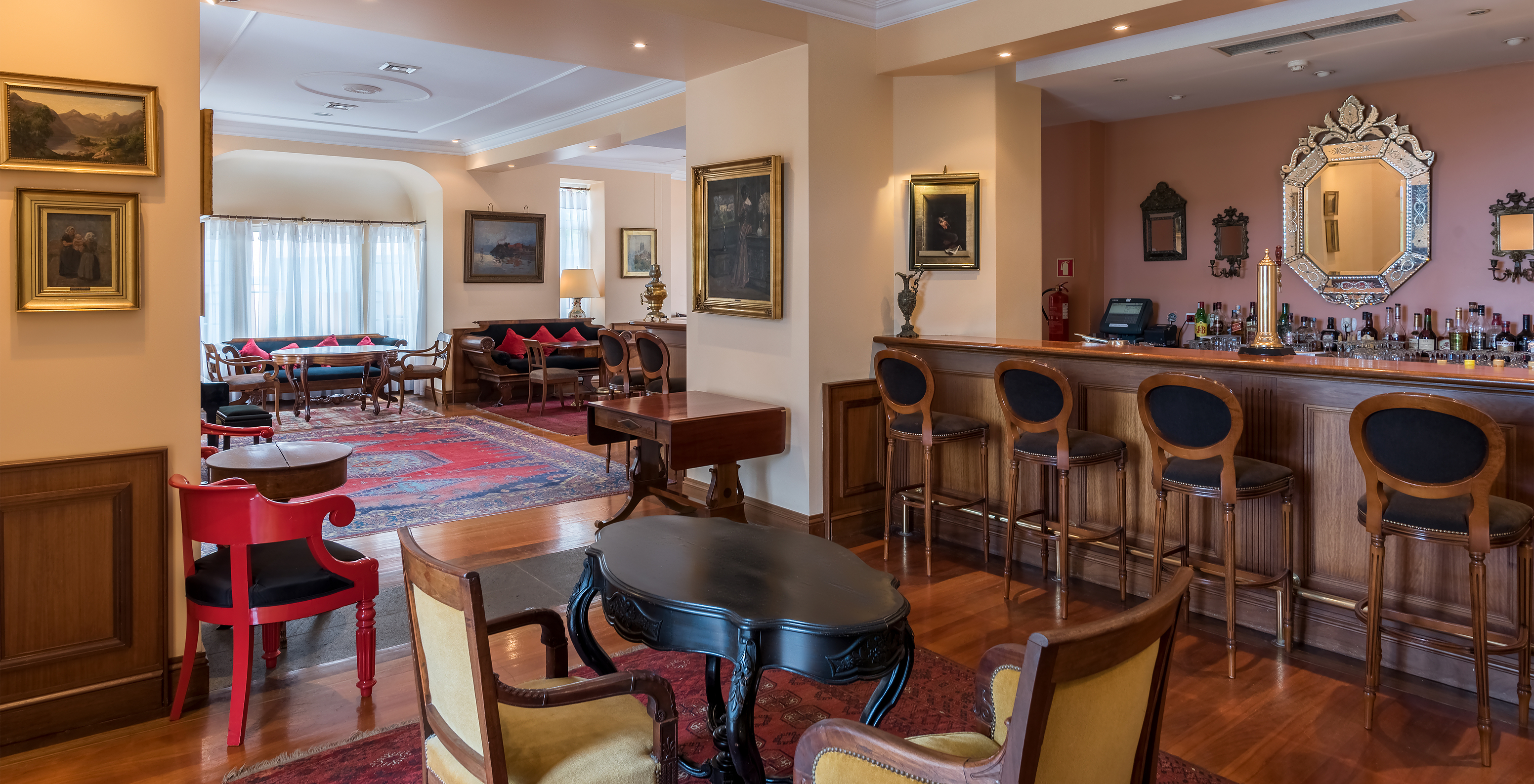 The A Fonte bar at the Romantic Hotel in Funchal, Madeira, has a counter with high chairs and several tables and sofas