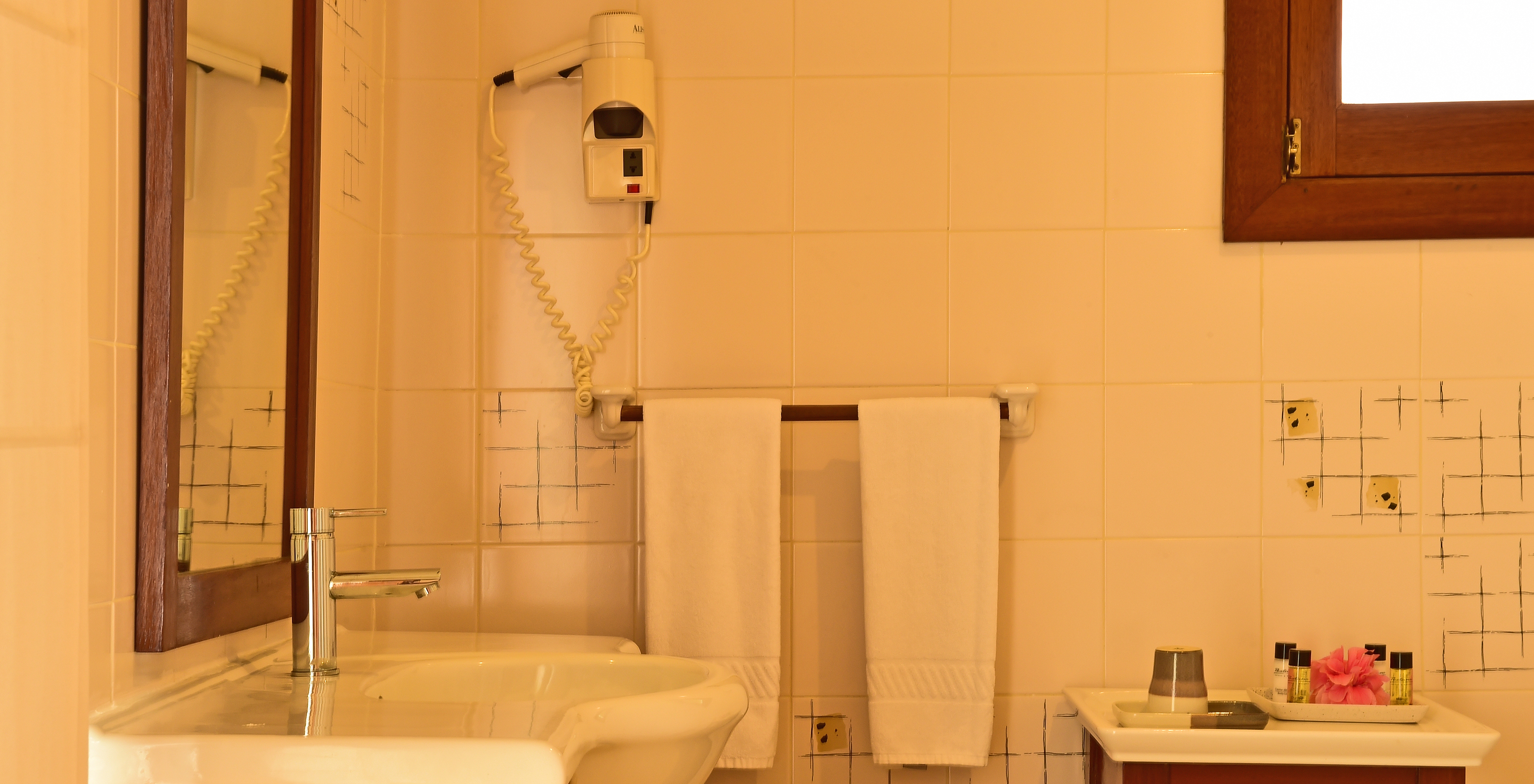 The Standard Double at Pestana Equador Ilheu das Rolas has a bathroom with a sink, mirror, and hairdryer