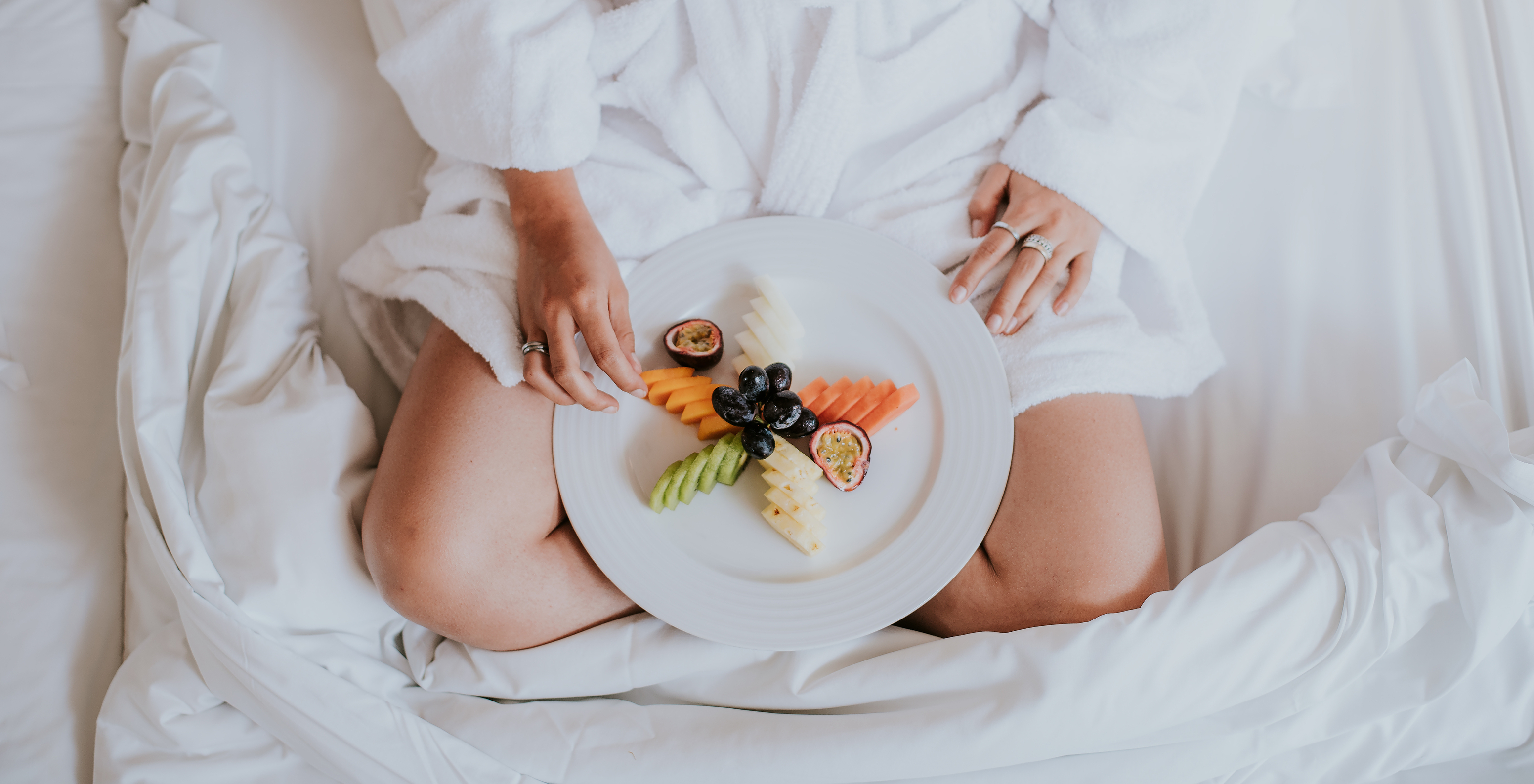 The Classic room at Pestana Miramar São Tomé offers breakfast in the room, with a lady carrying a plate of sliced fresh fruit