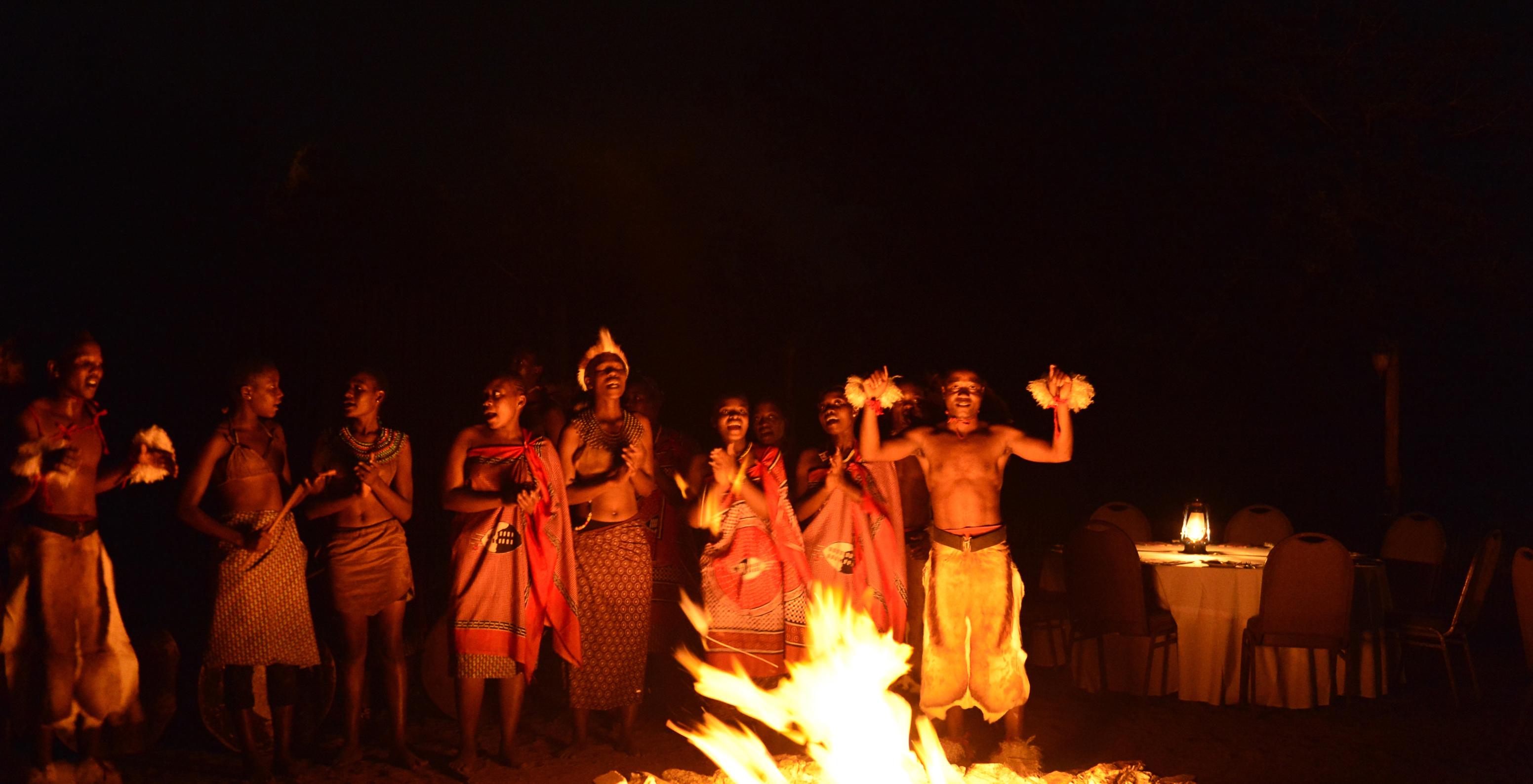 Traditional African animation with dances around fire for guests at a hotel with pool near Kruger Park