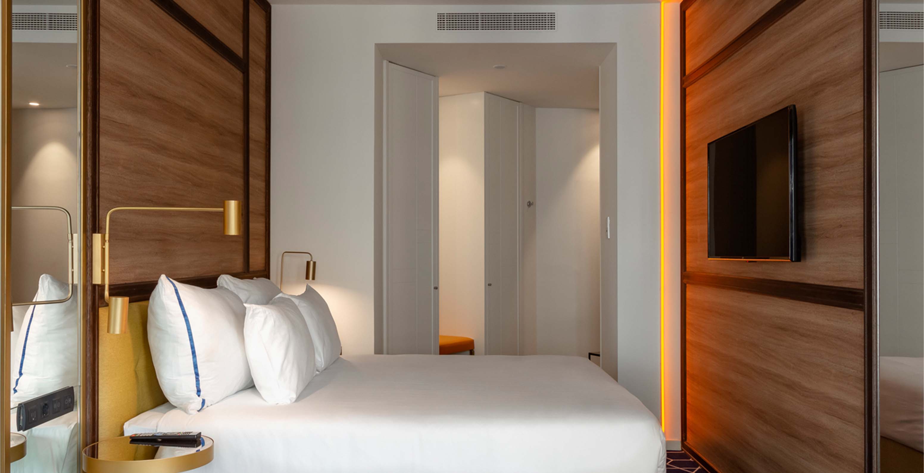 The Amazing CR7 Room at Pestana CR7 Gran Vía Madrid features a double bed, television, hexagonal rug, and entrance door