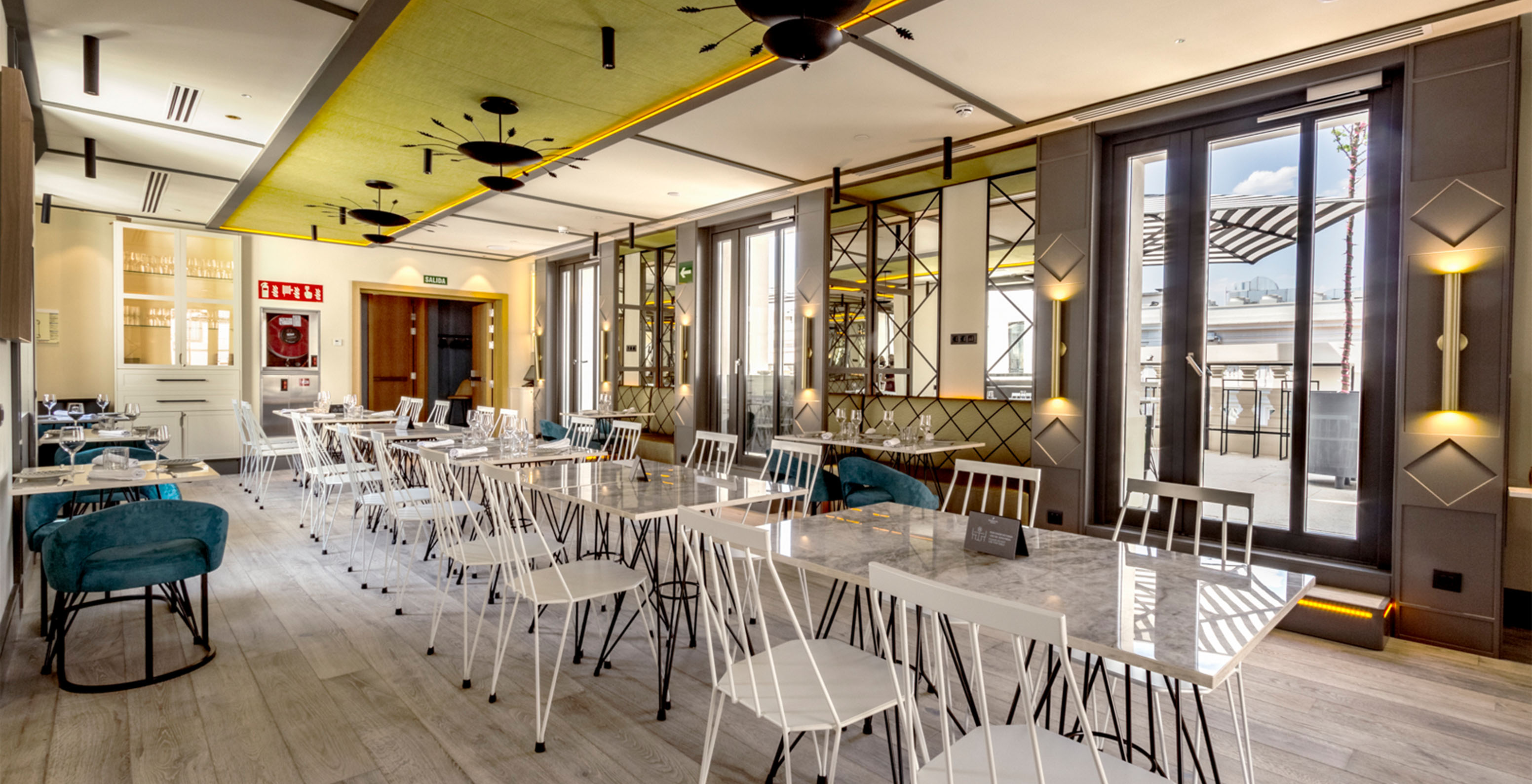 The Pizzaria restaurant at the hotel in central Madrid, Spain, has a modern indoor space with tables and sofas