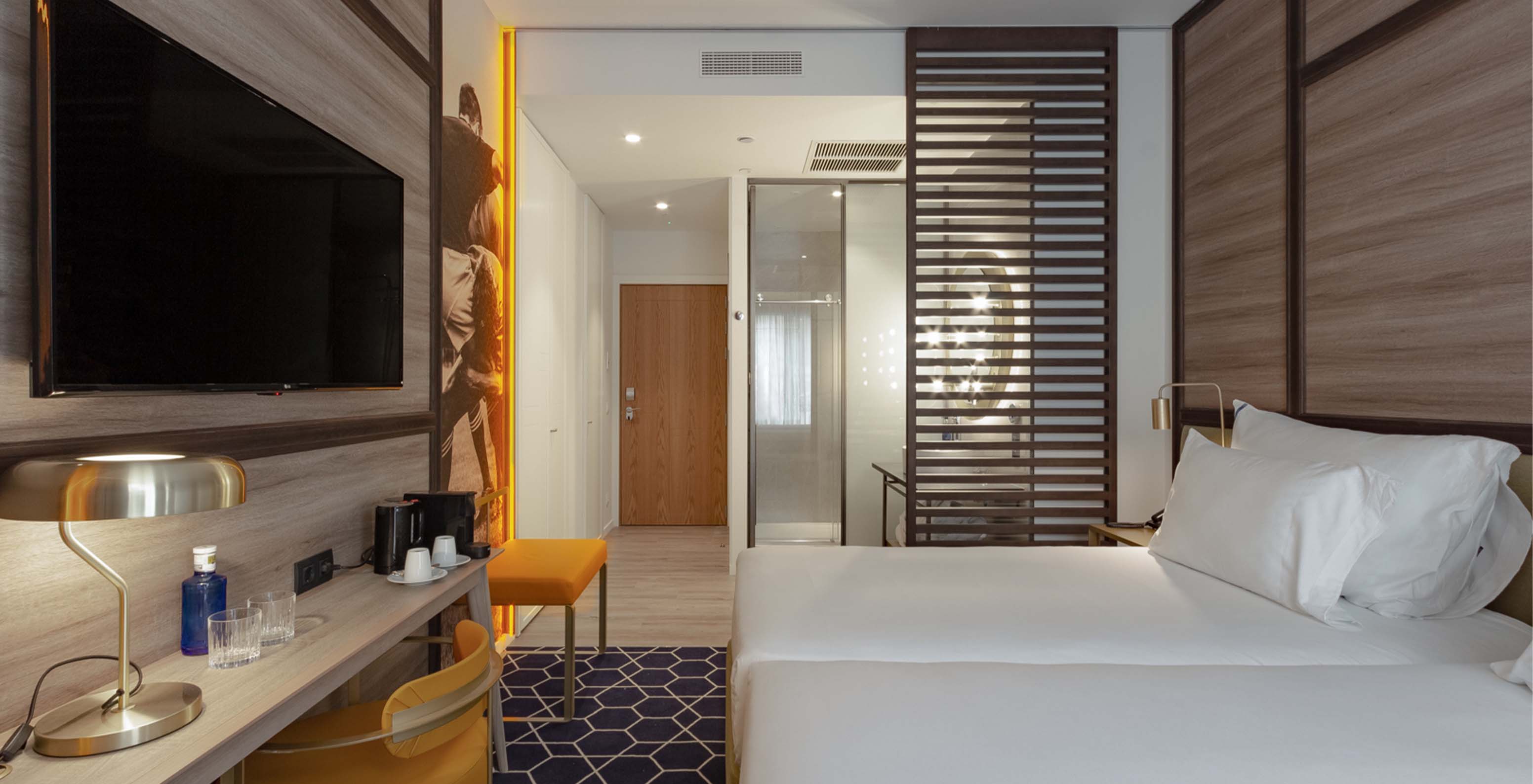 The Premium Room with View at Pestana CR7 Gran Vía Madrid has two beds and a wooden partition for the bathroom