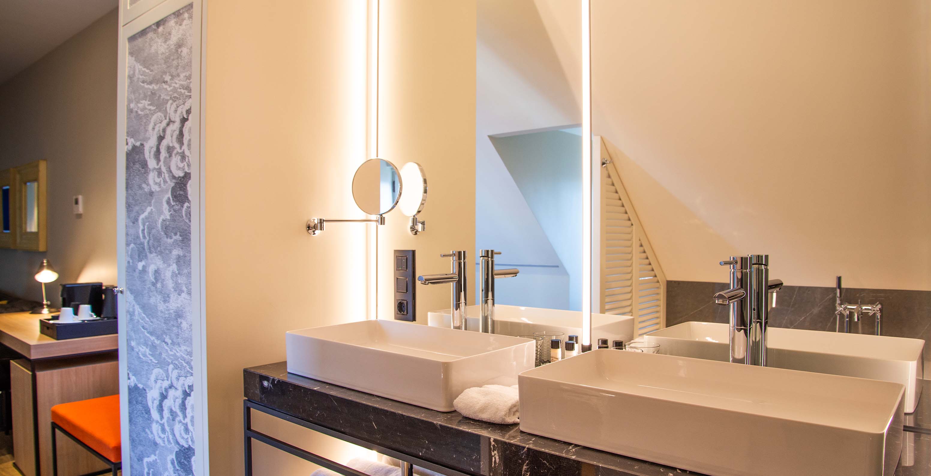 The Loft at Pestana Plaza Mayor Madrid has a bathroom with two sinks, large mirror and magnifying mirror