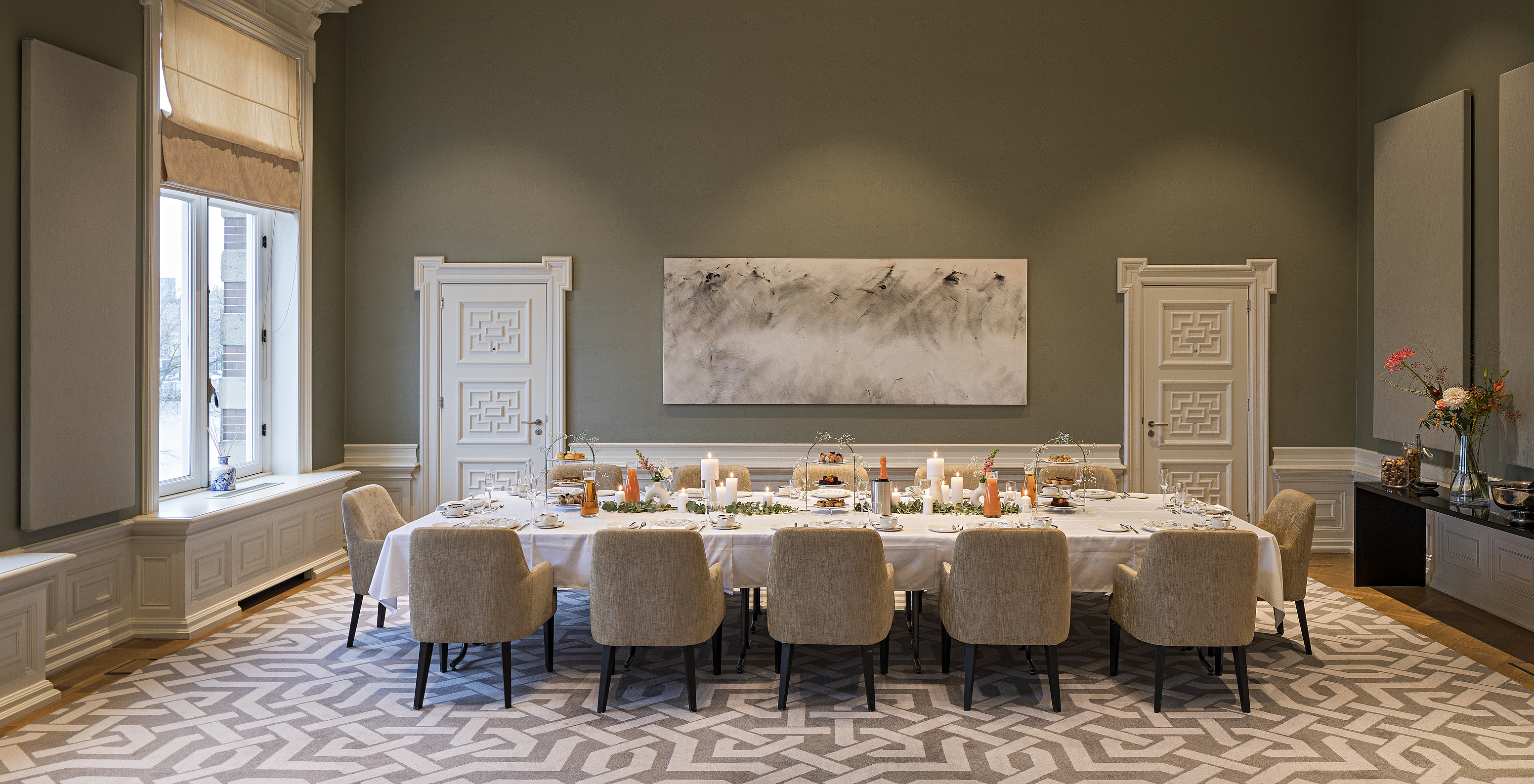 The Pestana Amsterdam Riverside, a hotel in downtown Amsterdam, has an event room with a large table and chairs