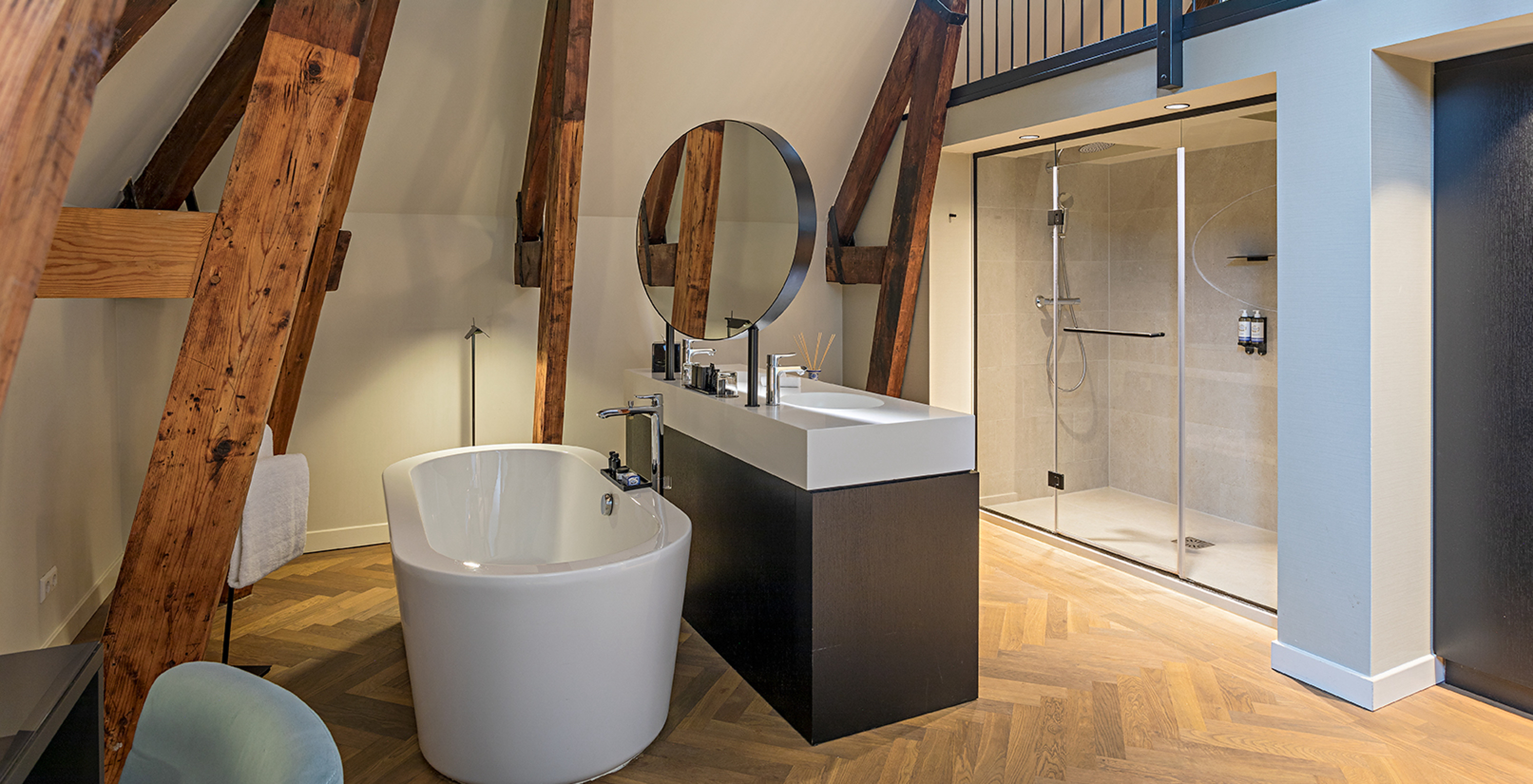 Clock Tower Suite at Pestana Amsterdam Riverside has a bathroom with two sinks, mirror and bathtub or shower