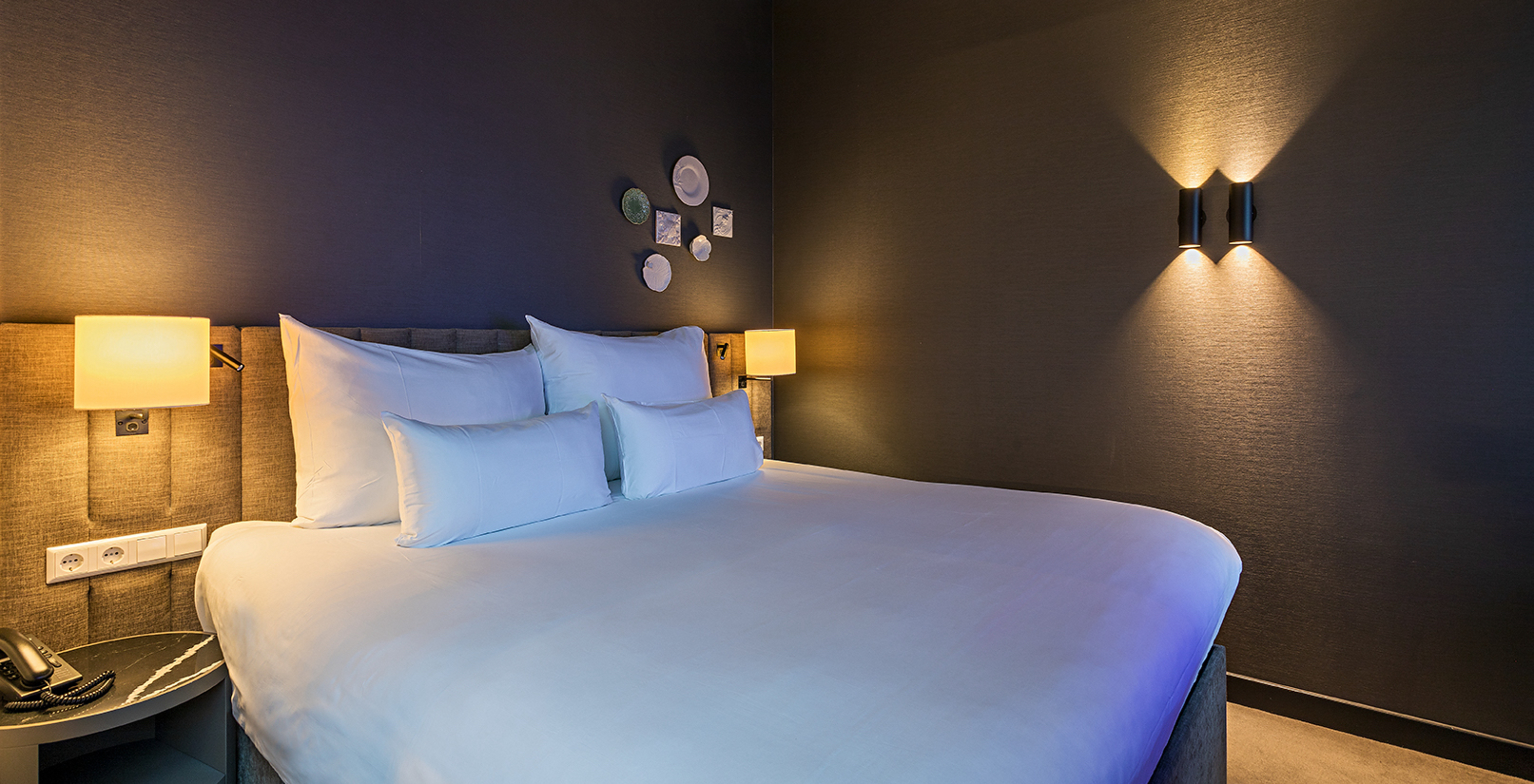 Loft room at Pestana Amsterdam Riverside has a double bed, with bedside table and lamp