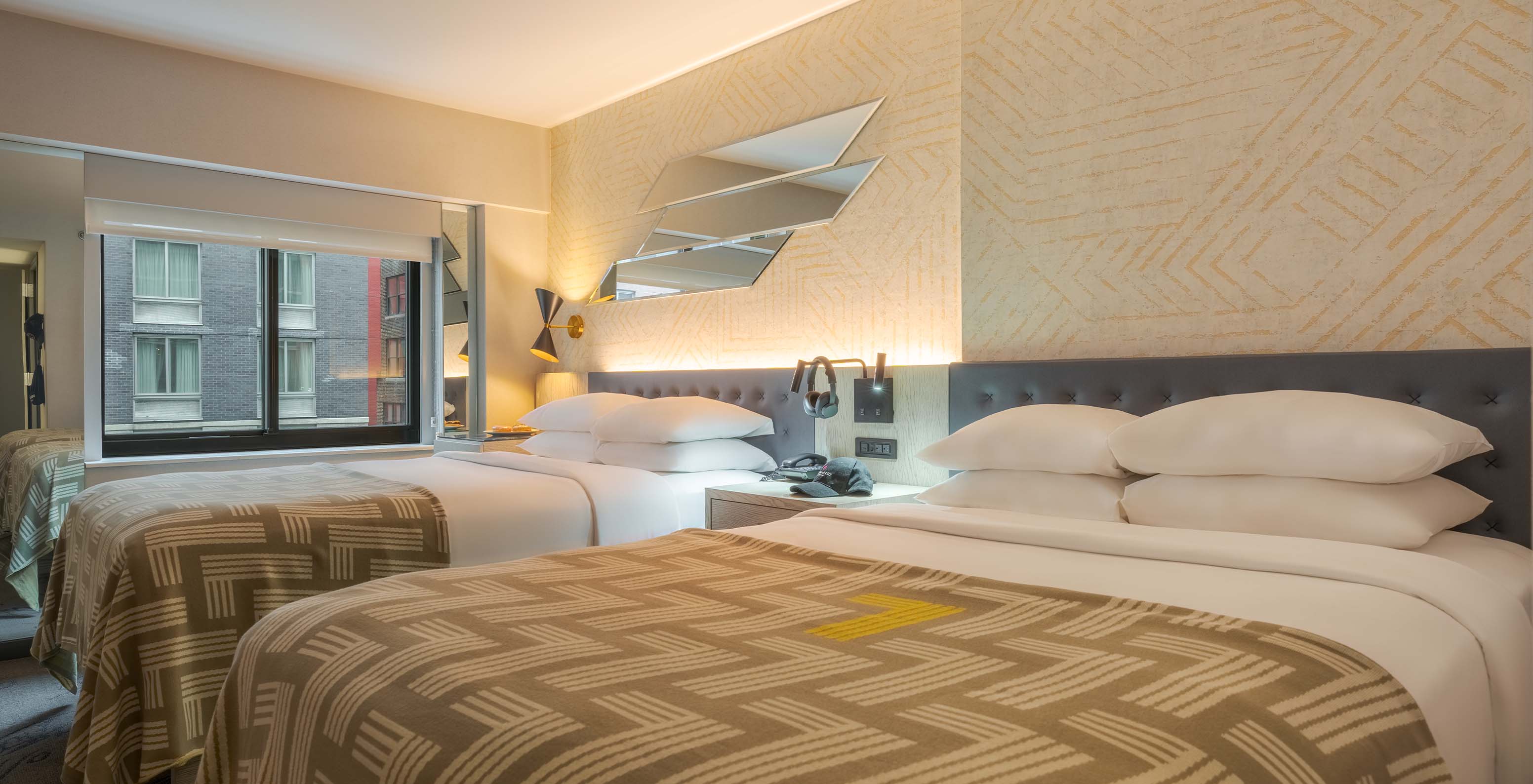 The Comfort Double at Pestana CR7 Times Square has two beds with a bedspread with the number seven and a window