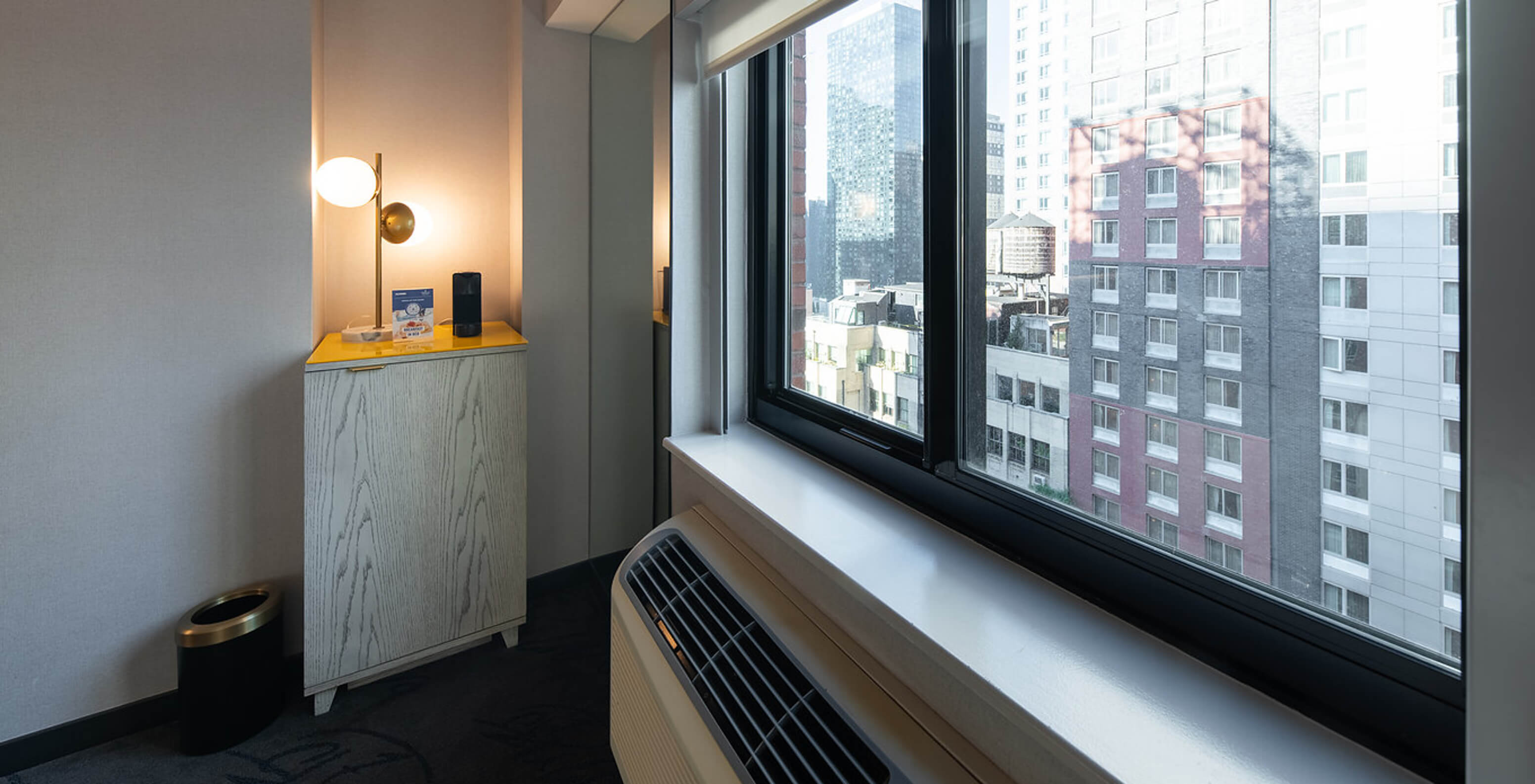 The Deluxe King Room ADA at Pestana CR7 Times Square has a city view window and air conditioning