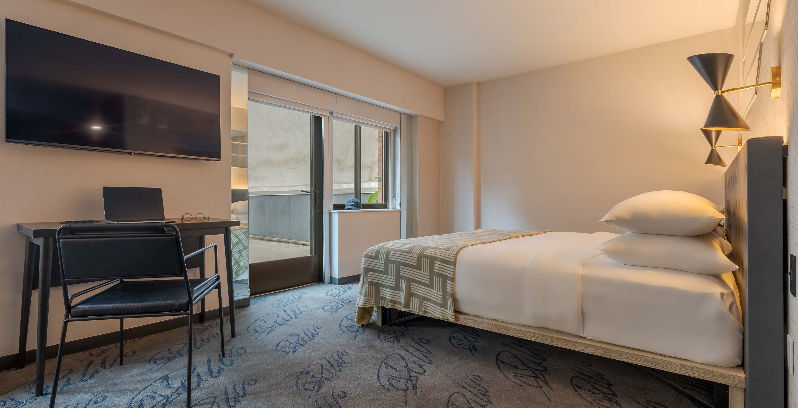 The ADA Junior Suite with Balcony and View at Pestana CR7 Times Square has a double bed, a TV, and a balcony