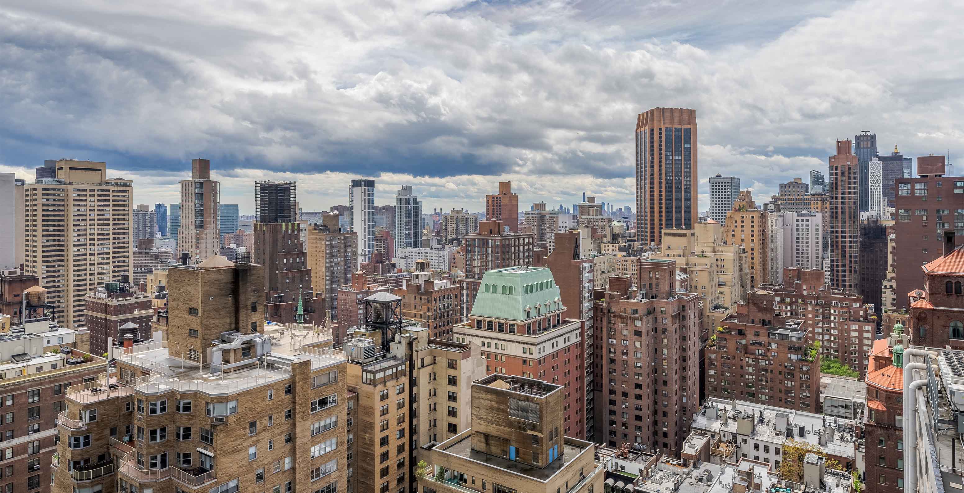 Panoramic view of Manhattan skyline, featuring buildings of varying heights and architectural styles