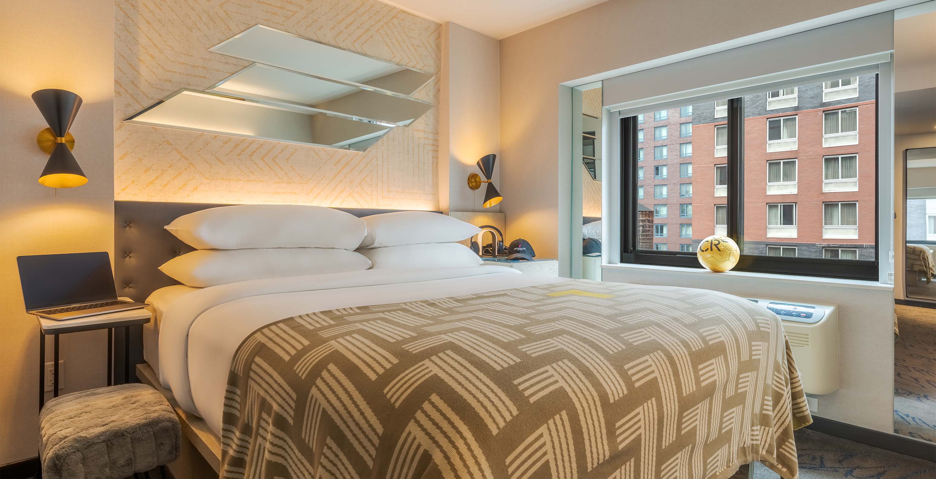 The Comfort Street View ADA at Pestana CR7 Times Square has a double bed with a bedspread with the number seven and a window