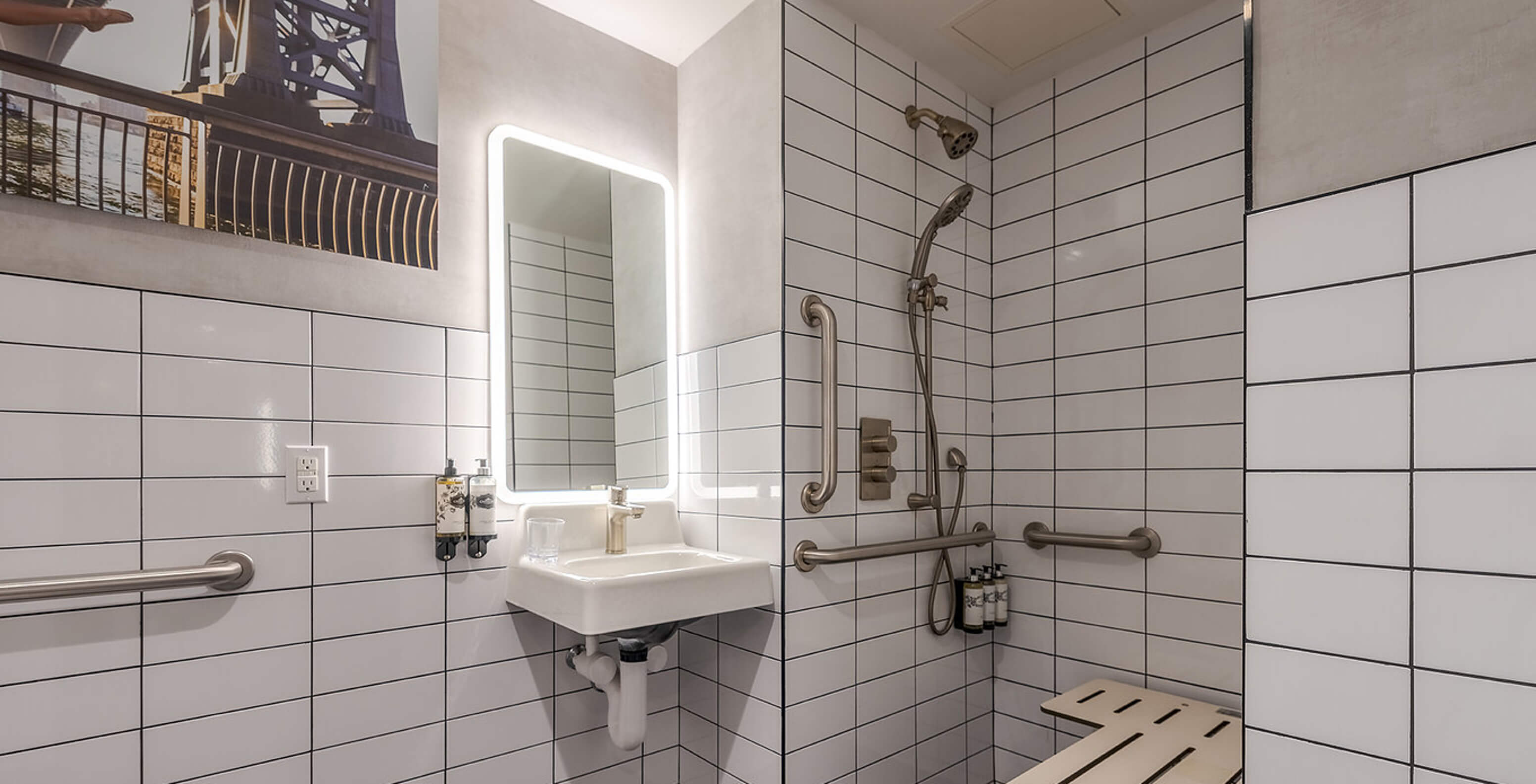 The Deluxe King Room ADA at Pestana CR7 Times Square has an adapted bathroom with sink and shower