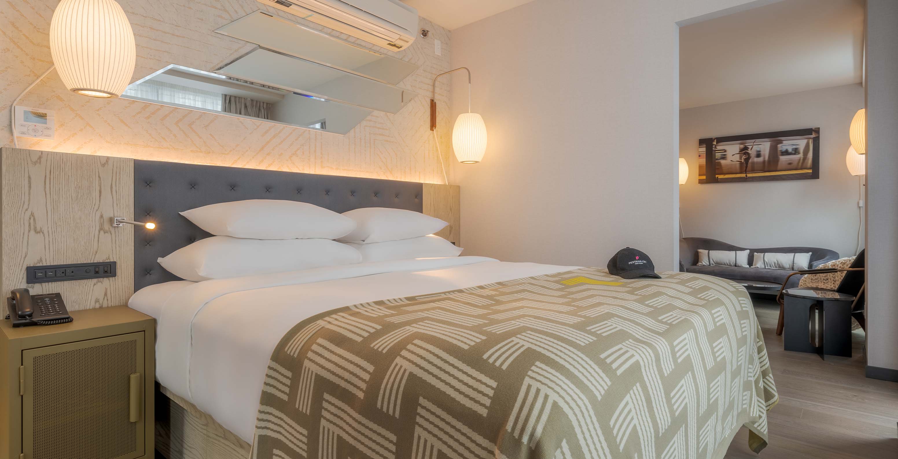 The Junior Suite with Balcony and View at Pestana CR7 Times Square has two beds with a bedspread with the number seven