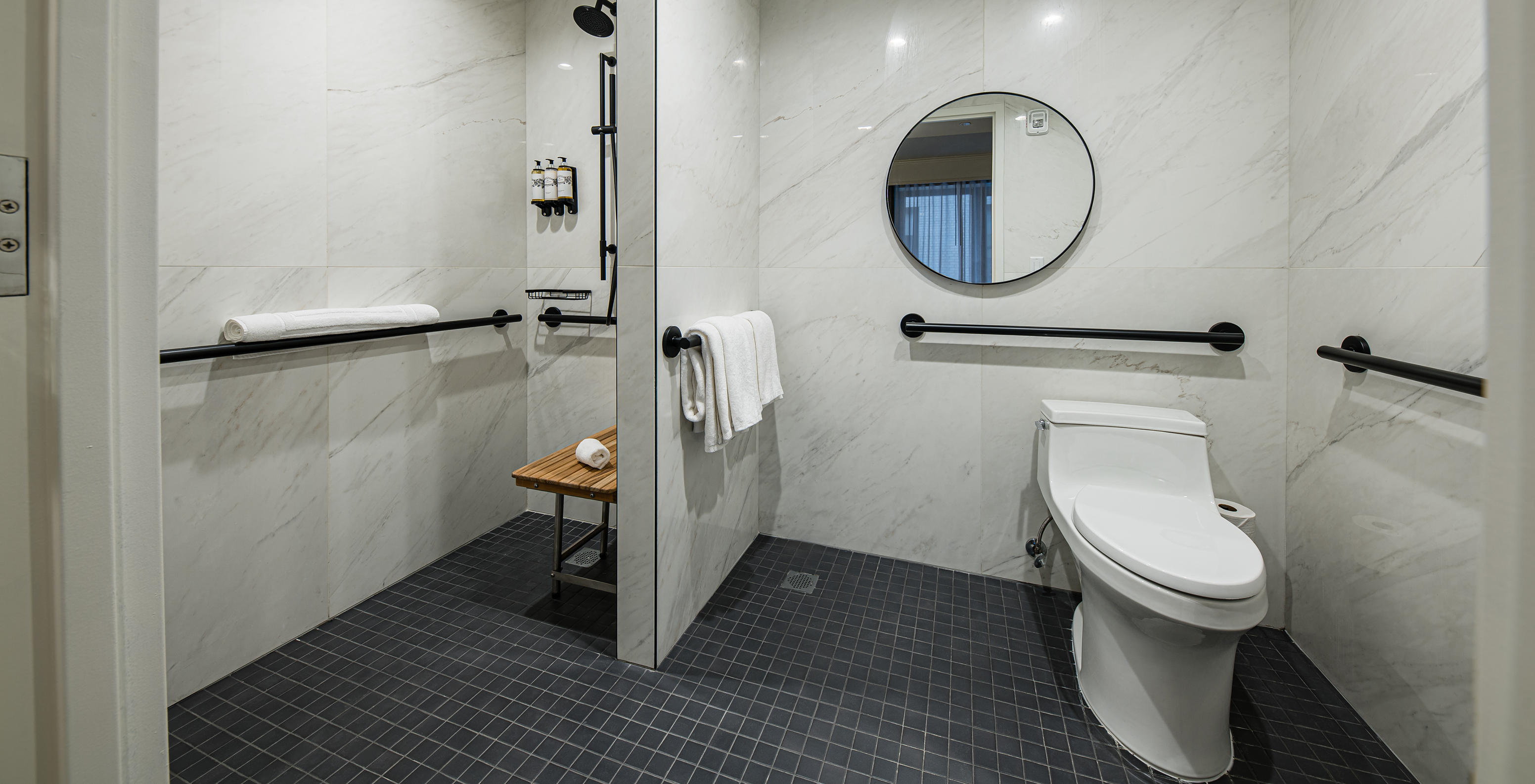 The Cabin room - ADA at Pestana Park Avenue has an adapted bathroom with shower, mirror and toilet