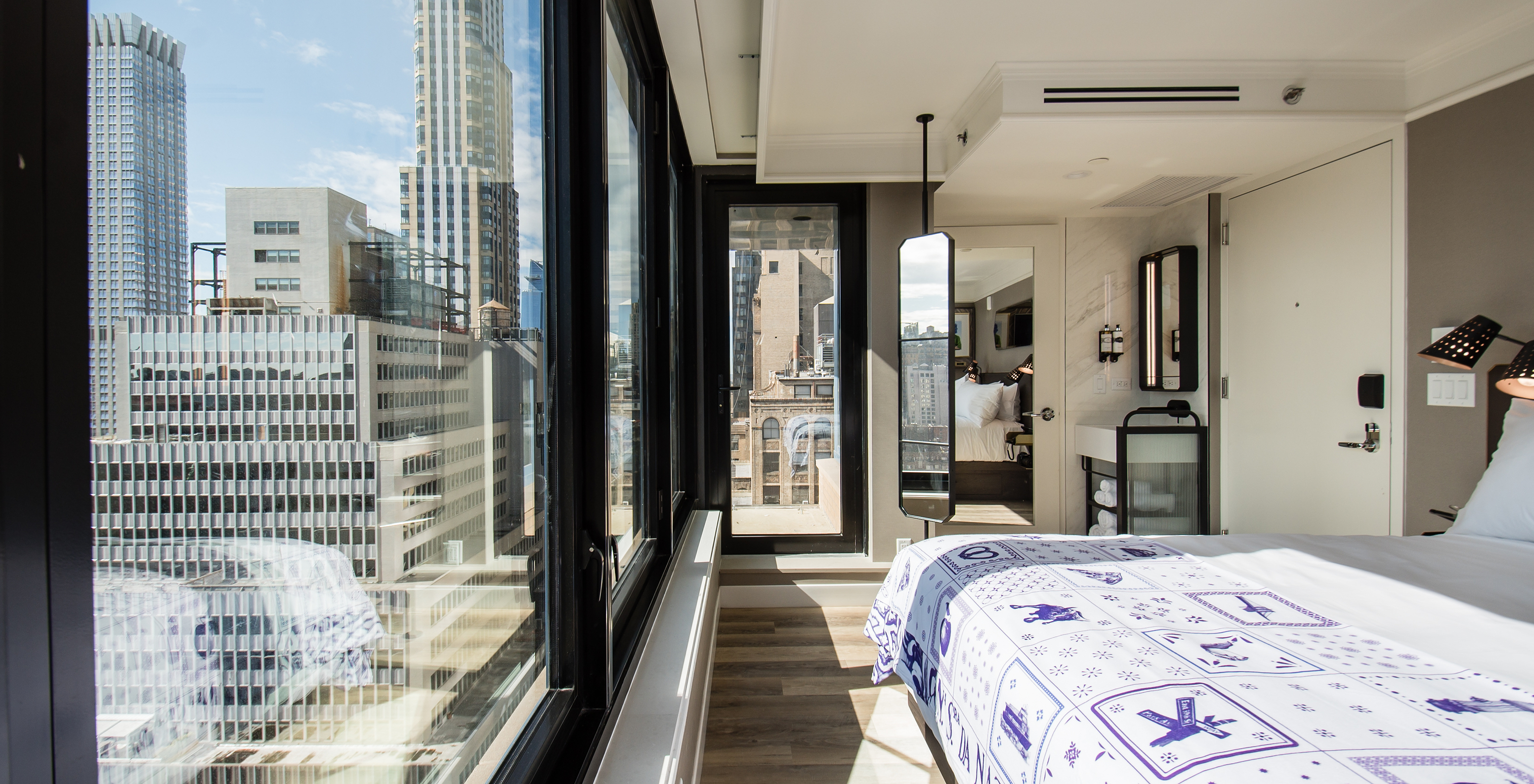 The Balcony room at Pestana Park Avenue has a double bed, a mirror, and a panoramic view of the city