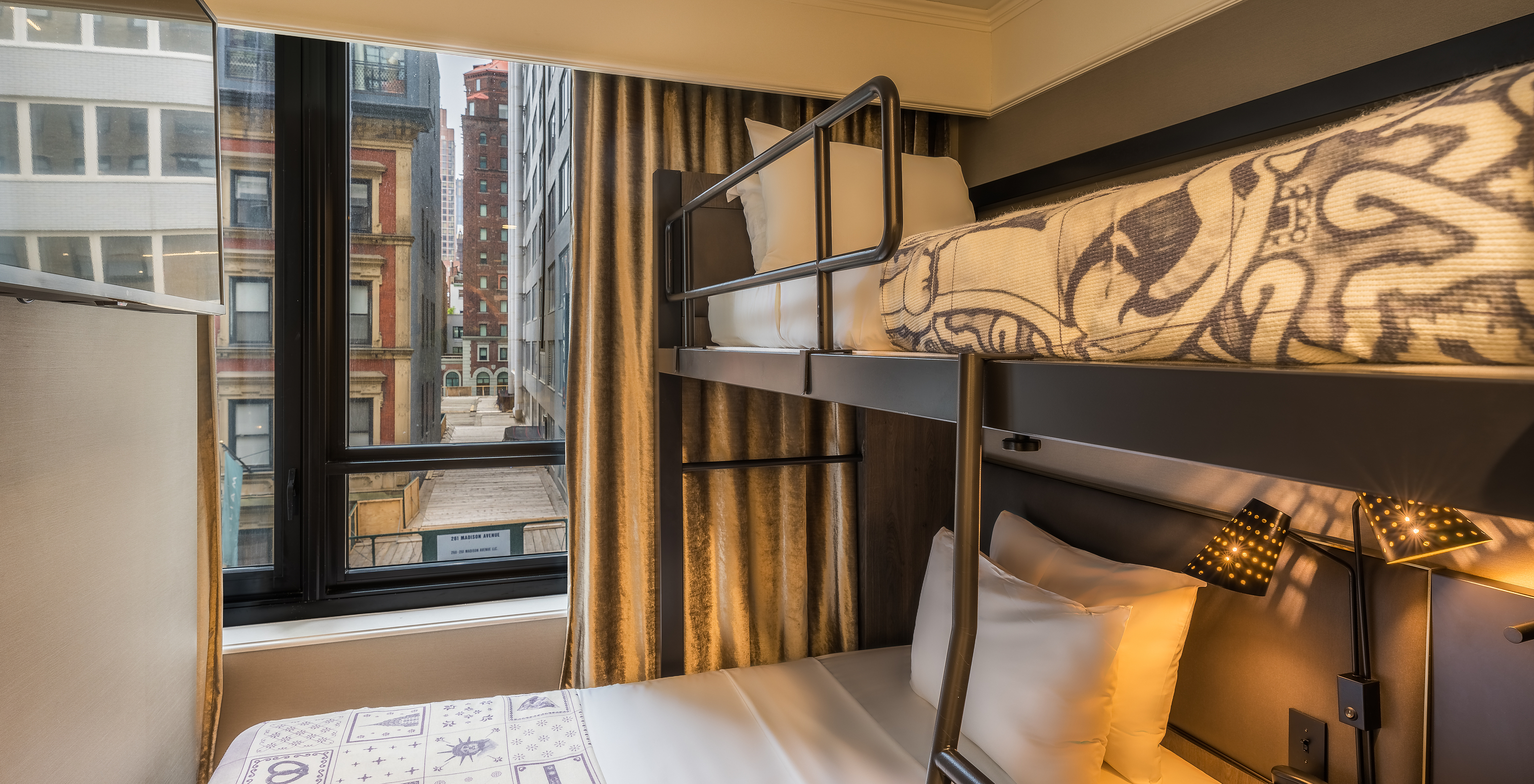 The Cabin room - ADA at Pestana Park Avenue has a bunk bed with two single beds and a view of the city