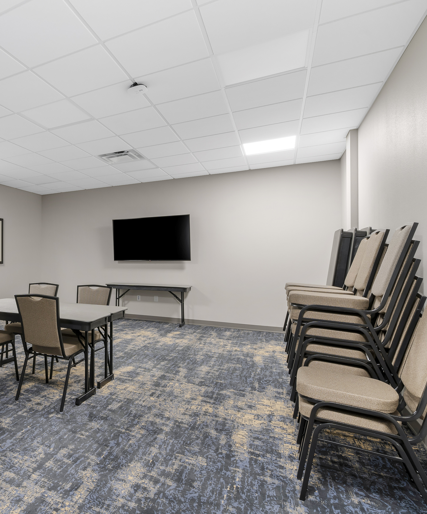 Pestana Orlando hotel with pool near Disney has a meeting room with table chairs and a television