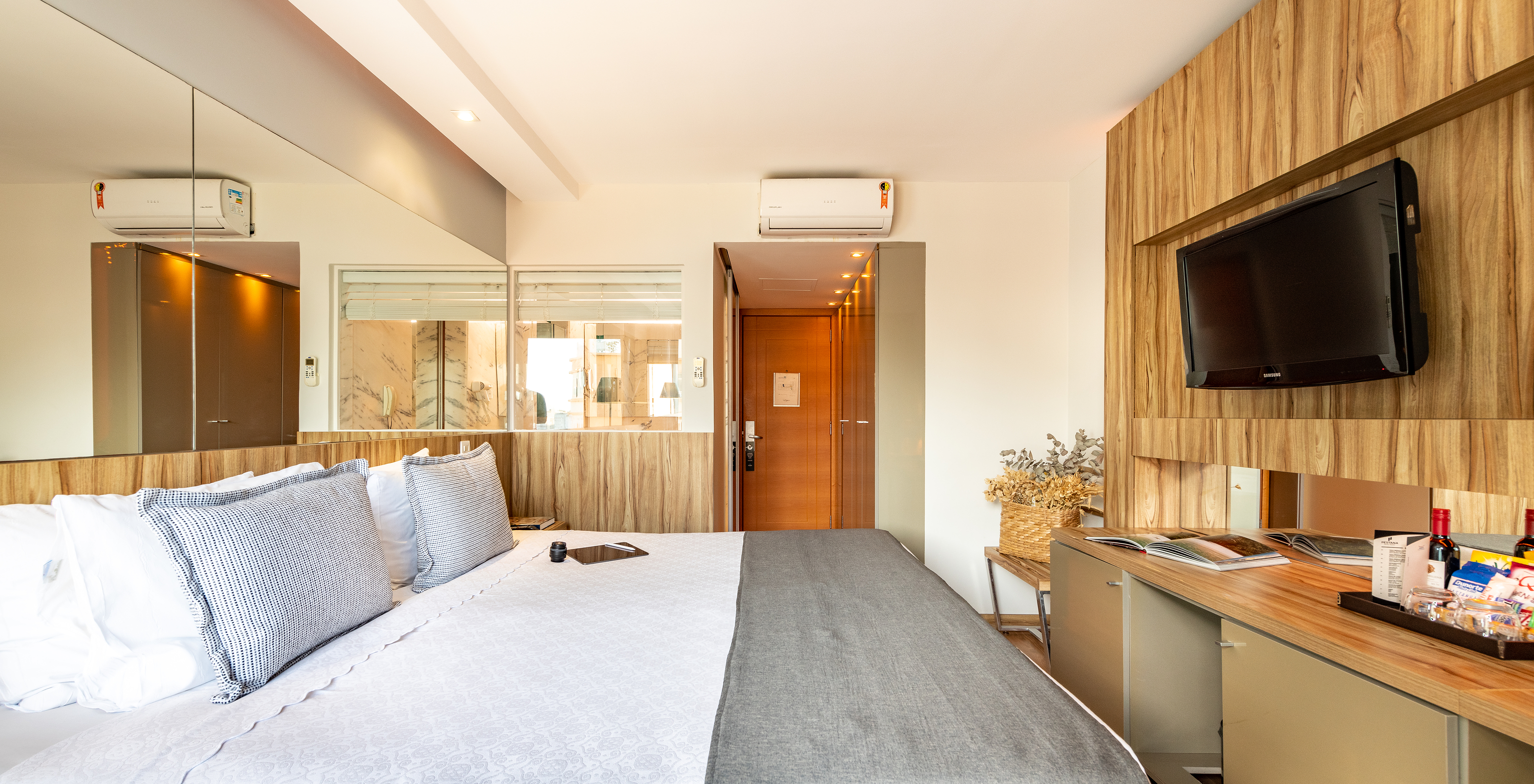 The Standard Double Room of Pestana Rio Atlântica has a double bed, mirror on the headboard, and a television in front