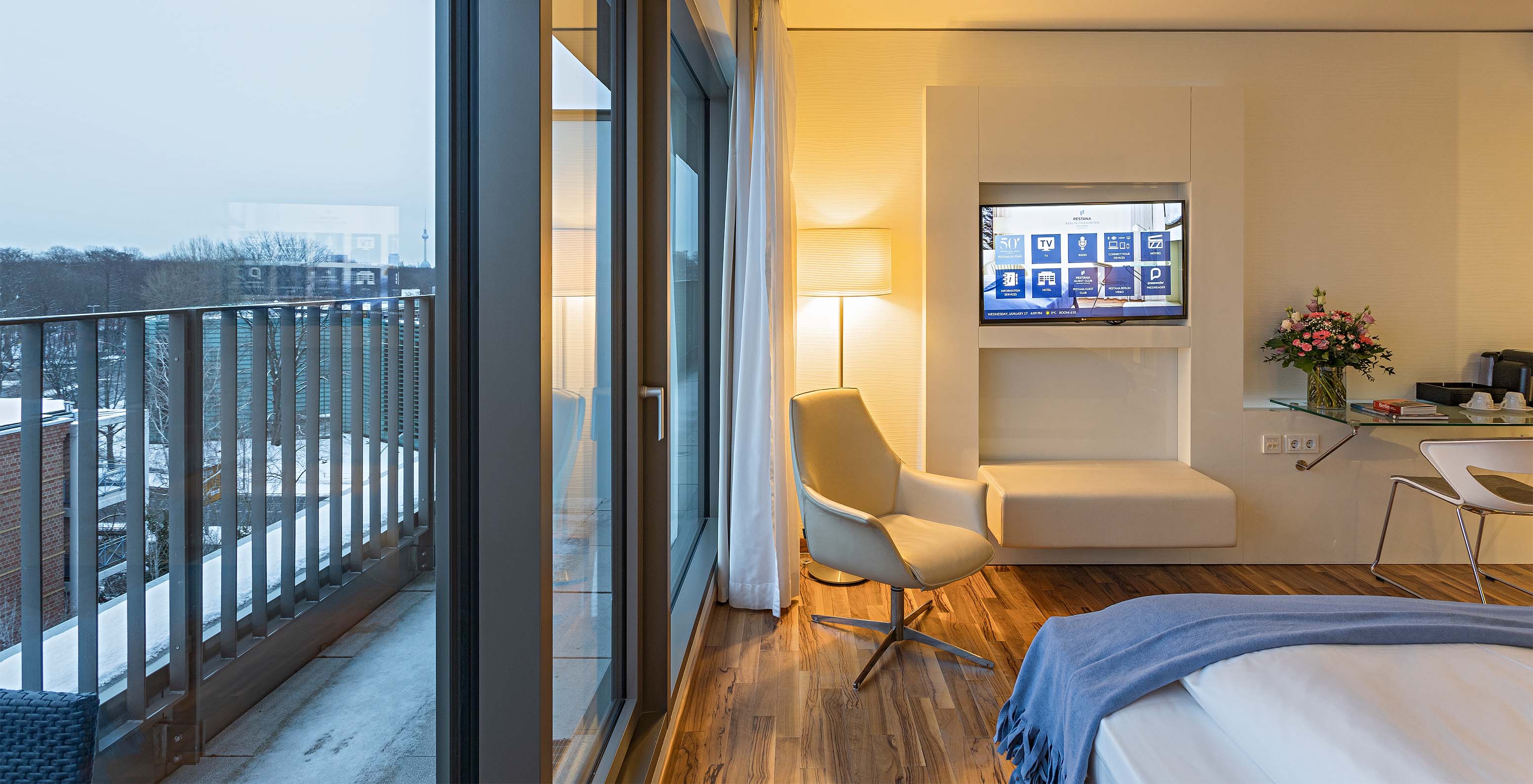 Premium Room with Balcony and View at Pestana Berlin Tiergarten has TV, balcony with view, and an armchair