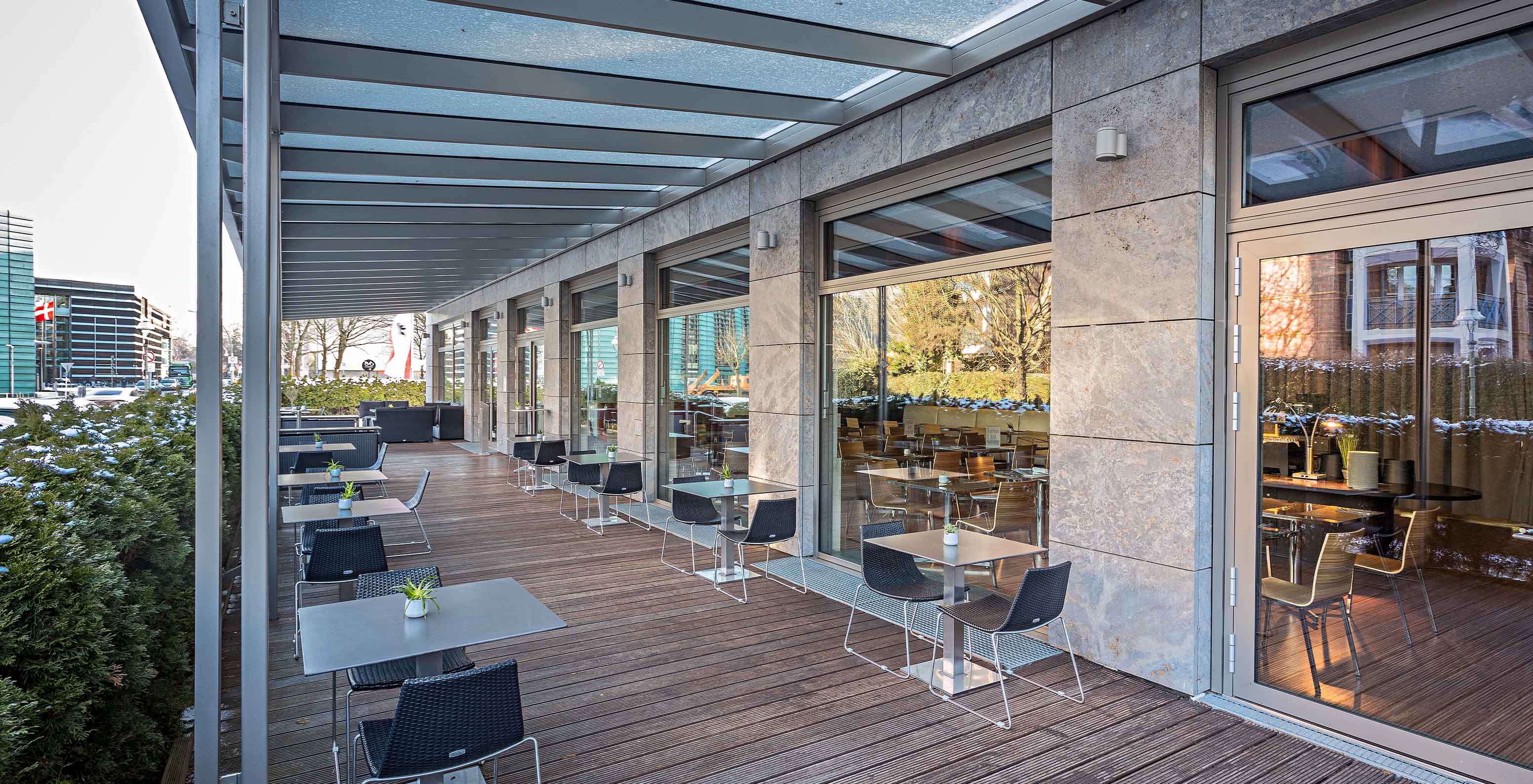 Pestana Berlin, a central hotel next to Tiergarten, features an outdoor terrace facing the street with tables and chairs