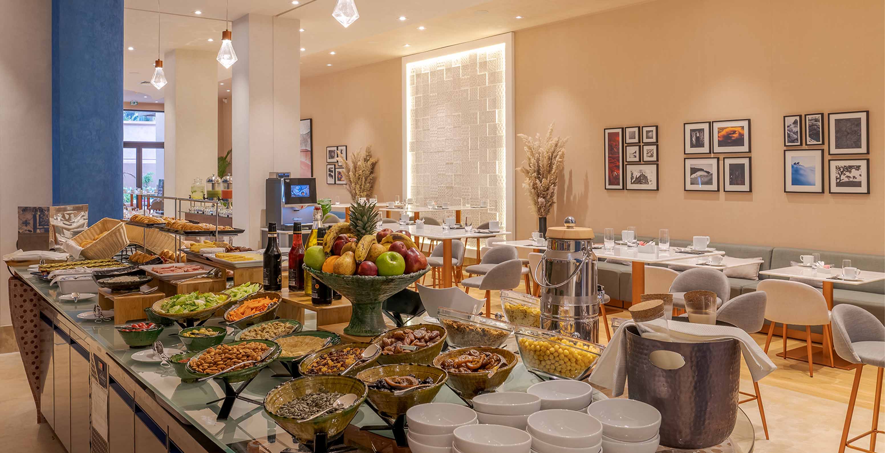 Breakfast at Lifestyle Hotel in Morocco with pool has several options including cereals, fruit, bread, cakes, and coffee