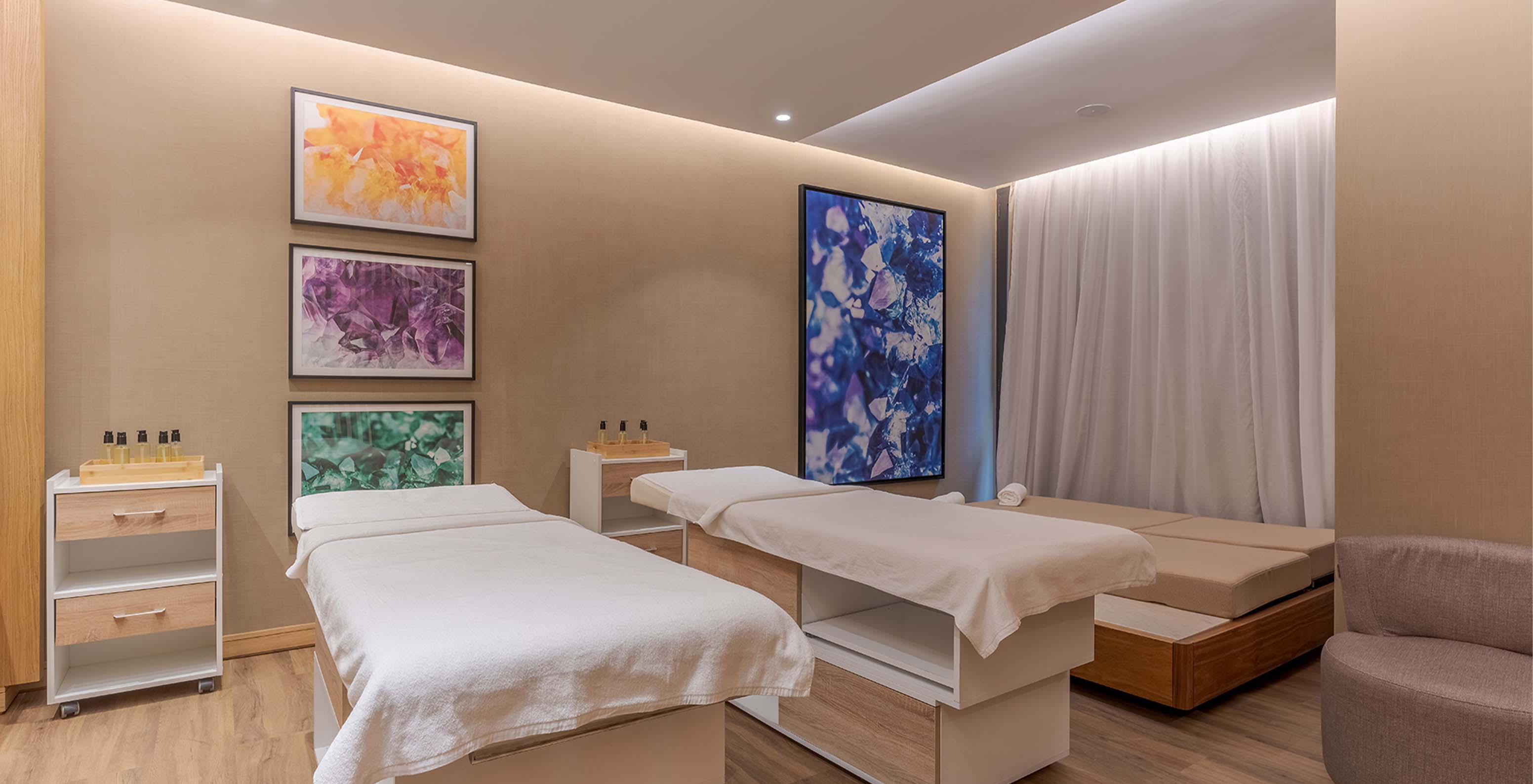 Massage and treatment room, with two beds and a sofa, at Lifestyle Hotel in Morocco with pool