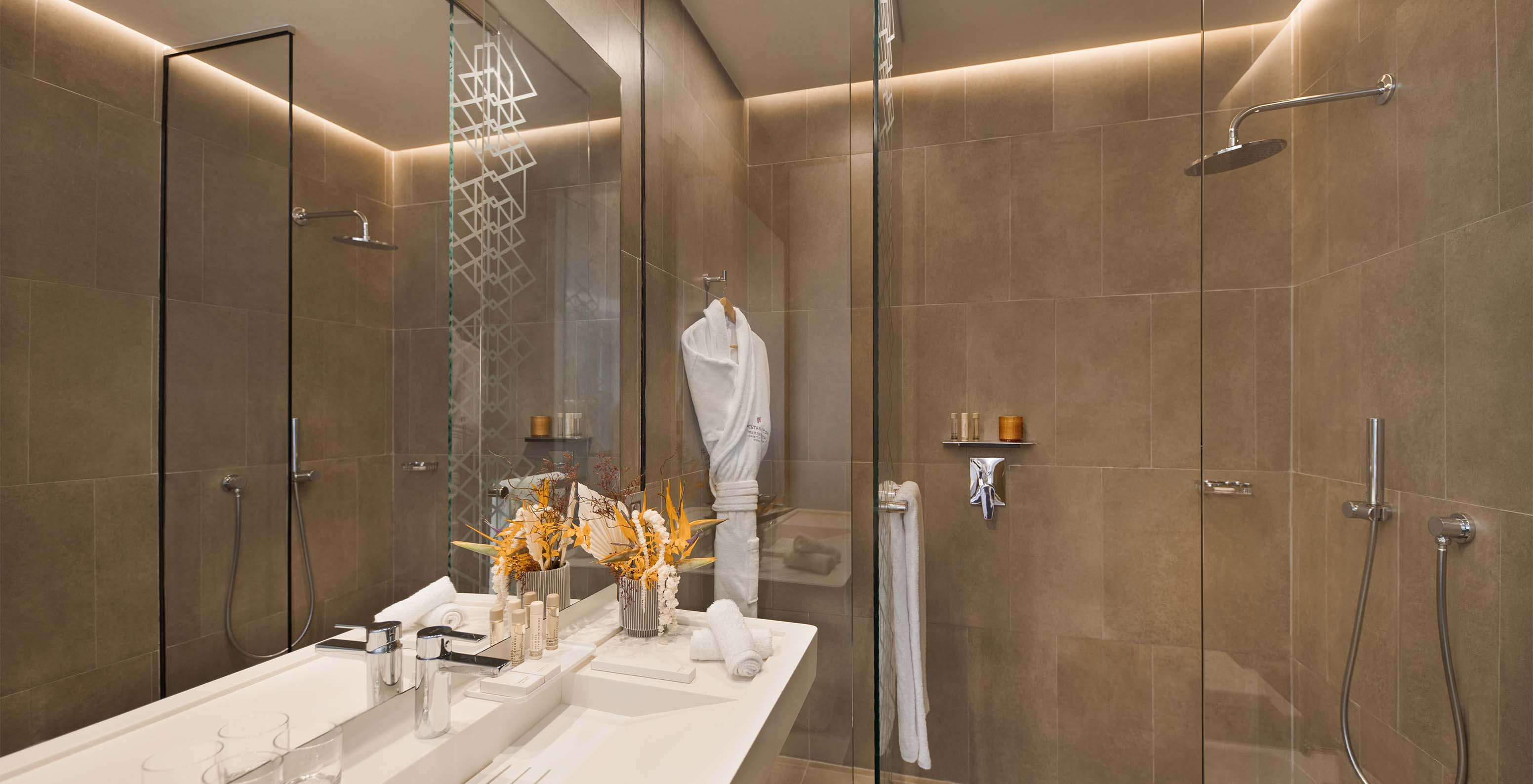 The CR7 Room at Pestana CR7 Marrakech has a bathroom with a walk-in shower, sink with mirror, and various amenities