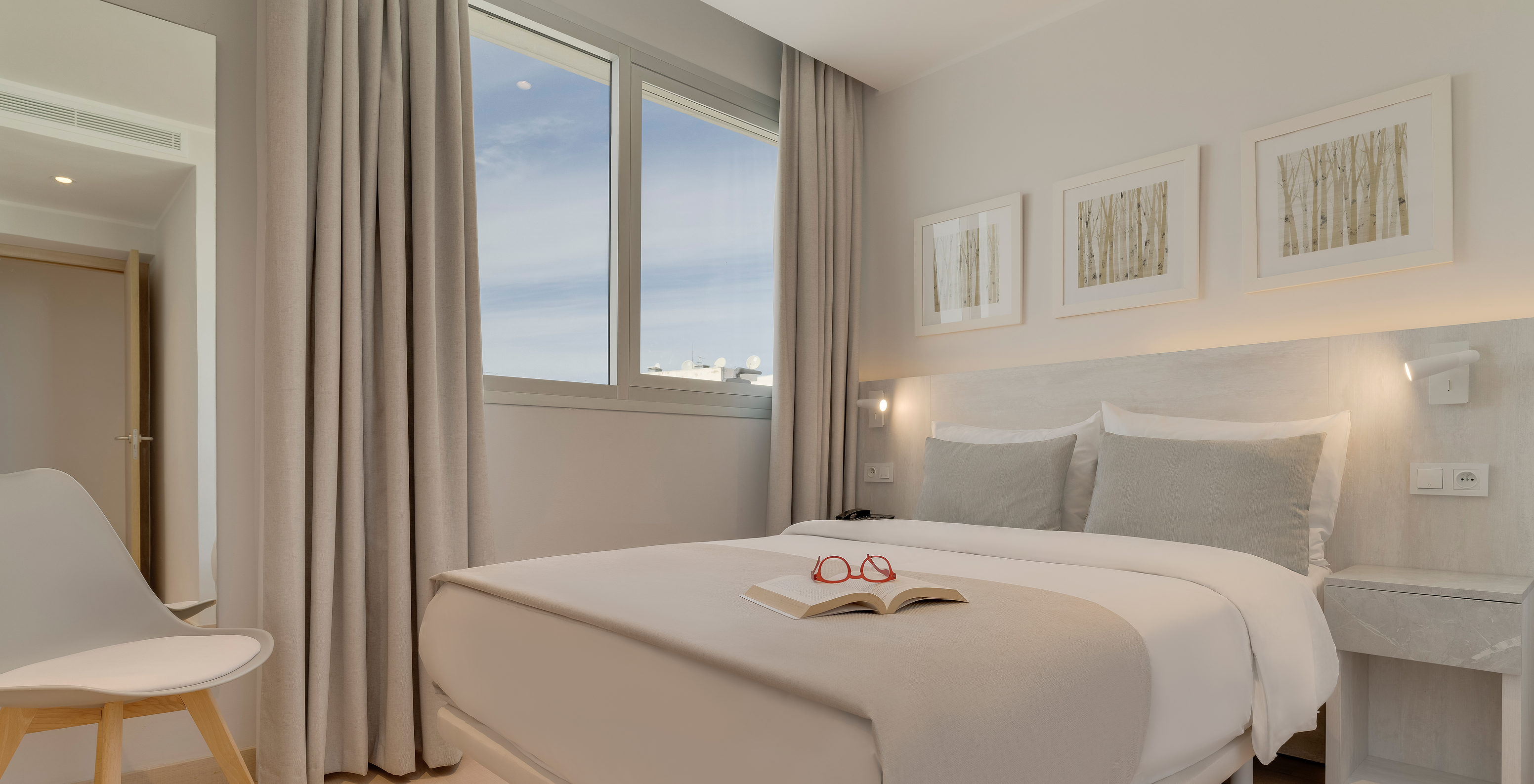 The Family Suite of Pestana Tanger City Center features a double bed with stone headboard, a window, and a chair