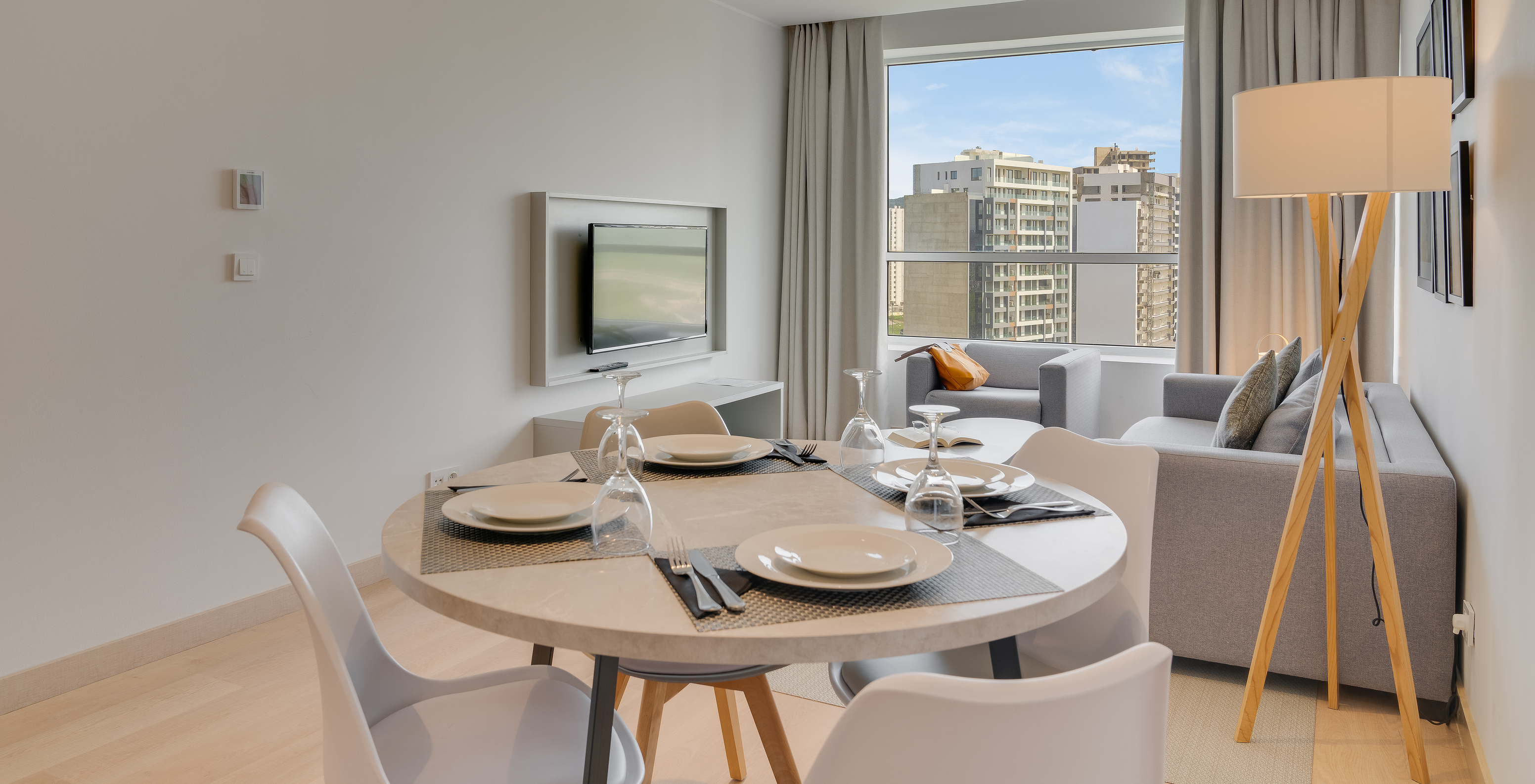 The Family Premium Suite of Pestana Tanger City Center features a living room with television, sofa, and dining table