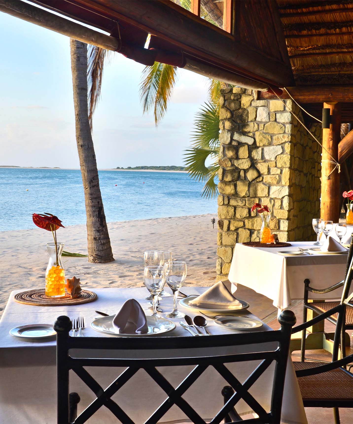 Restaurant on the beach at Pestana Bazaruto Lodge in a covered structure but open on the sides