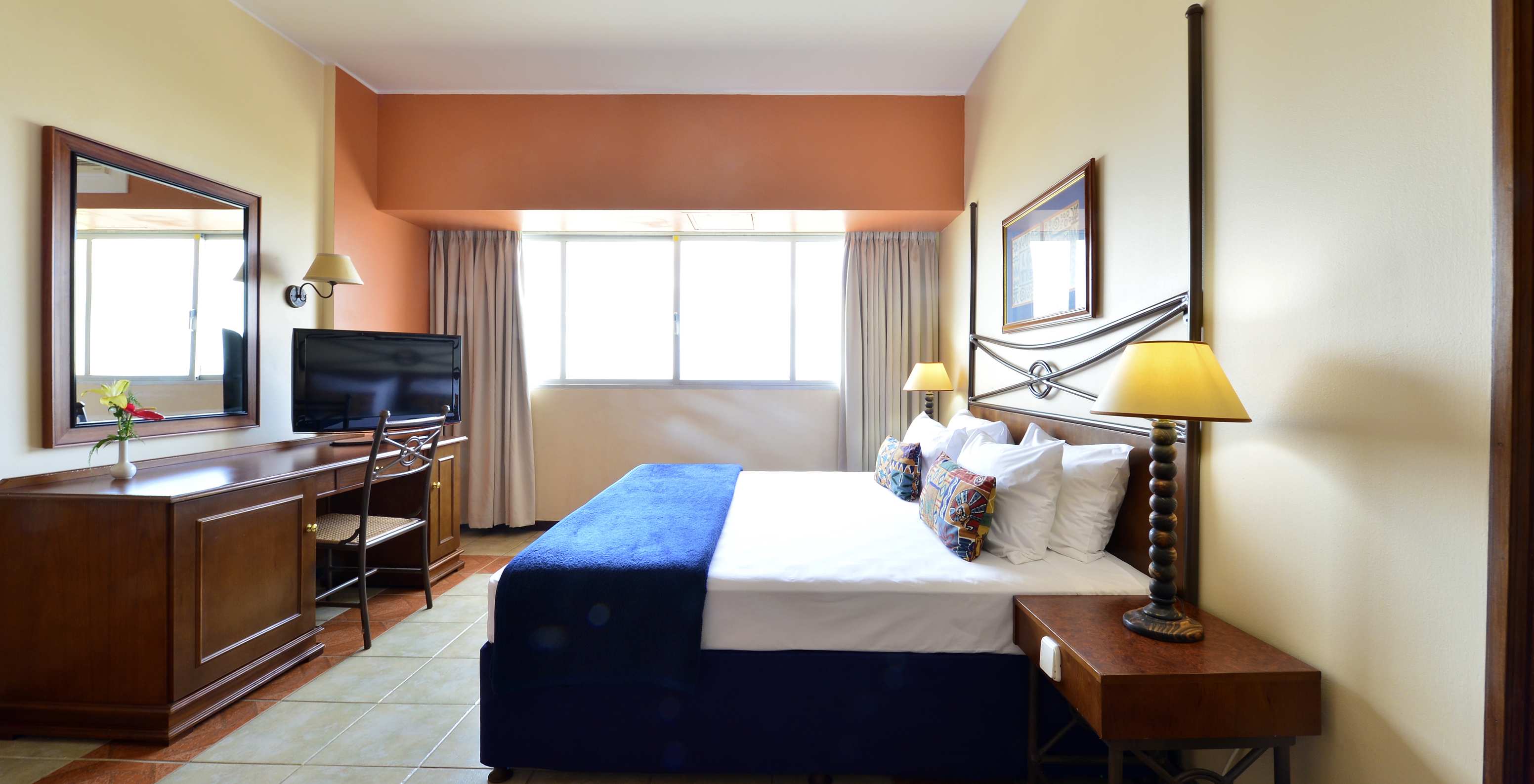 The Executive Suite of Pestana Rovuma has a double bed, desk with television, and a large window