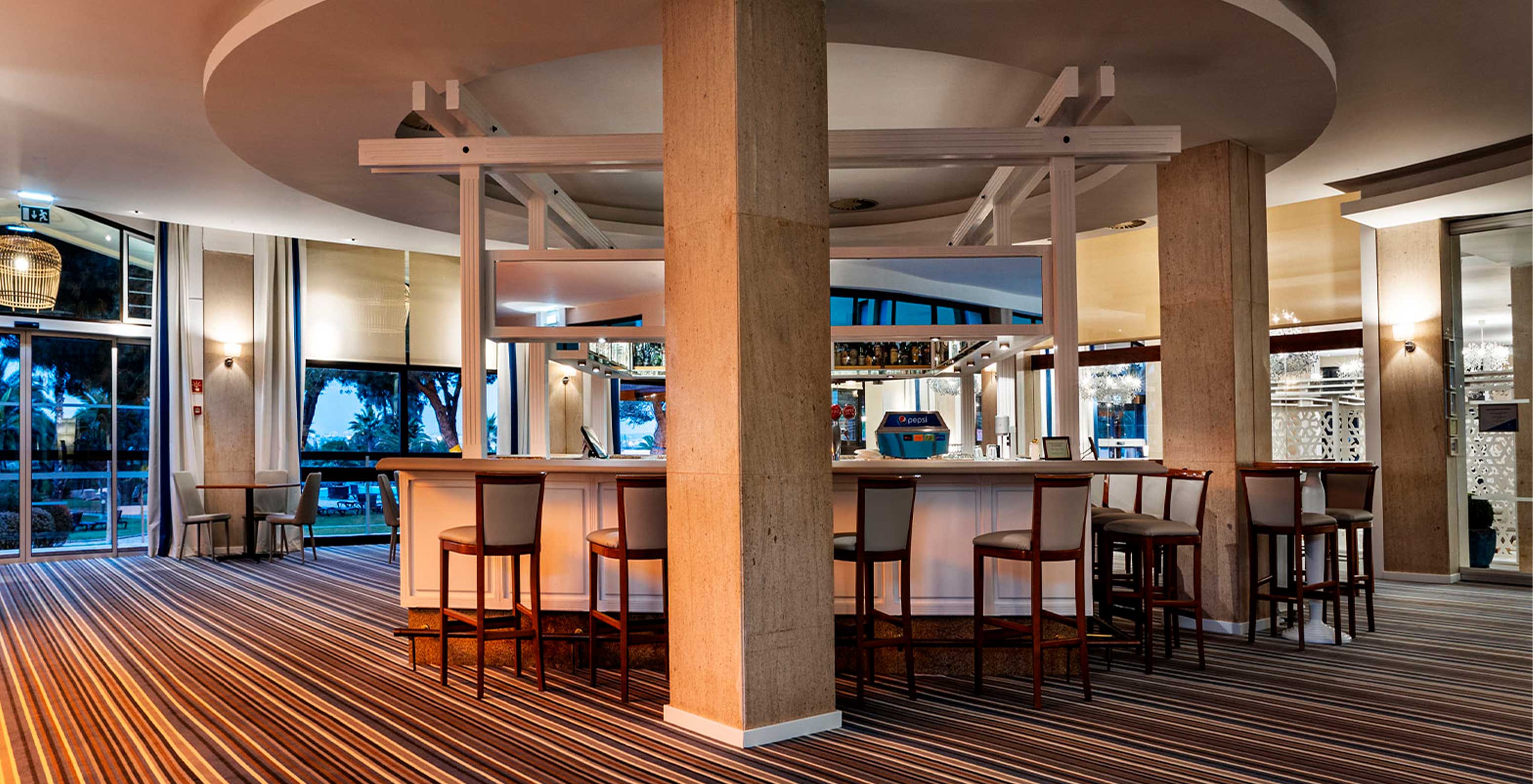 The Bar do Princípe features a spacious area with tall chairs and a bar serving drinks