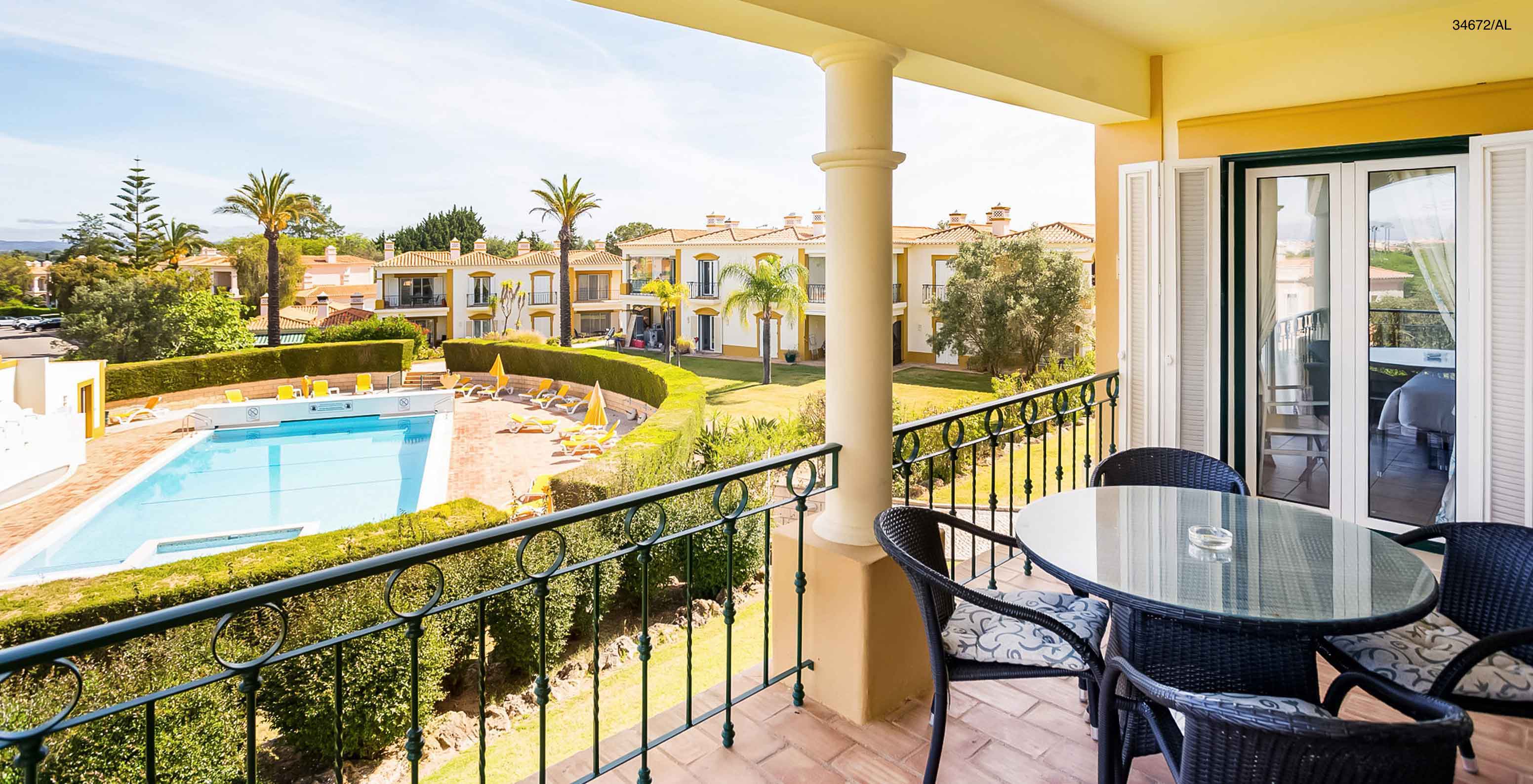 The Pestana Carvoeiro Golf T2 Superior Apartment has a balcony with a pool and garden view