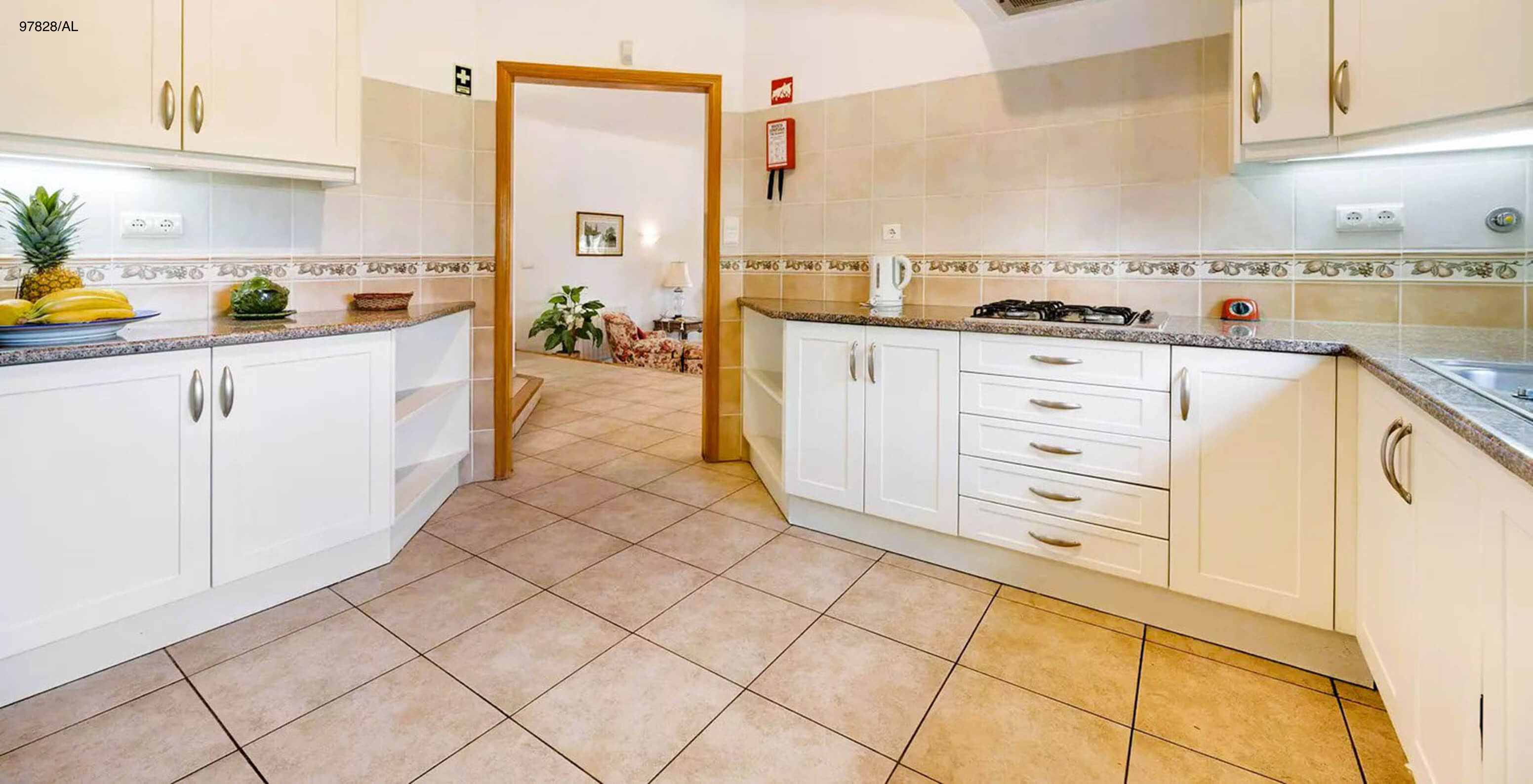 The Pestana Carvoeiro Golf V3 Standard Villa has a kitchen equipped with white cabinets and appliances