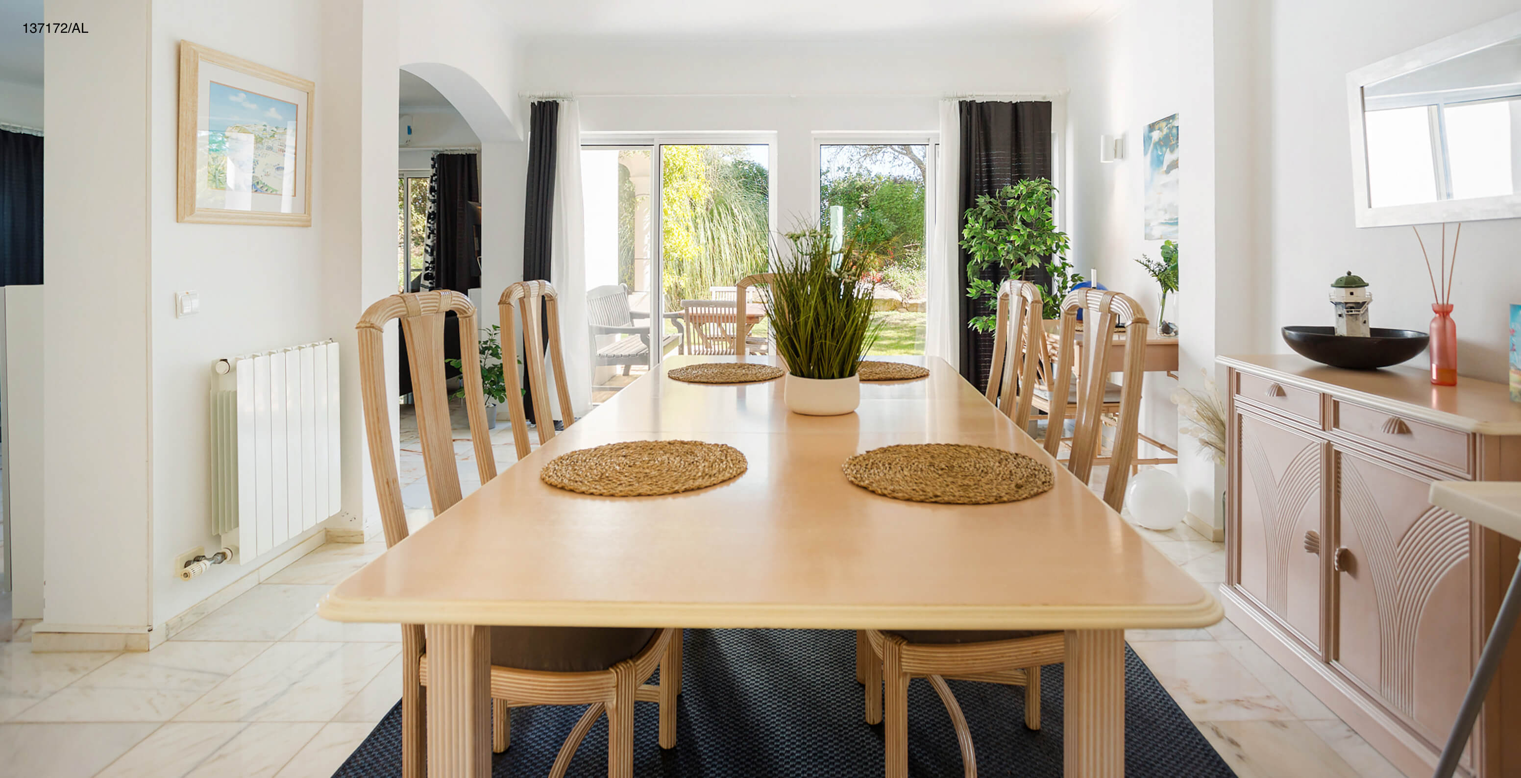 The Pestana Carvoeiro Golf V3 Standard Villa has a dining room with a long wooden table and chairs