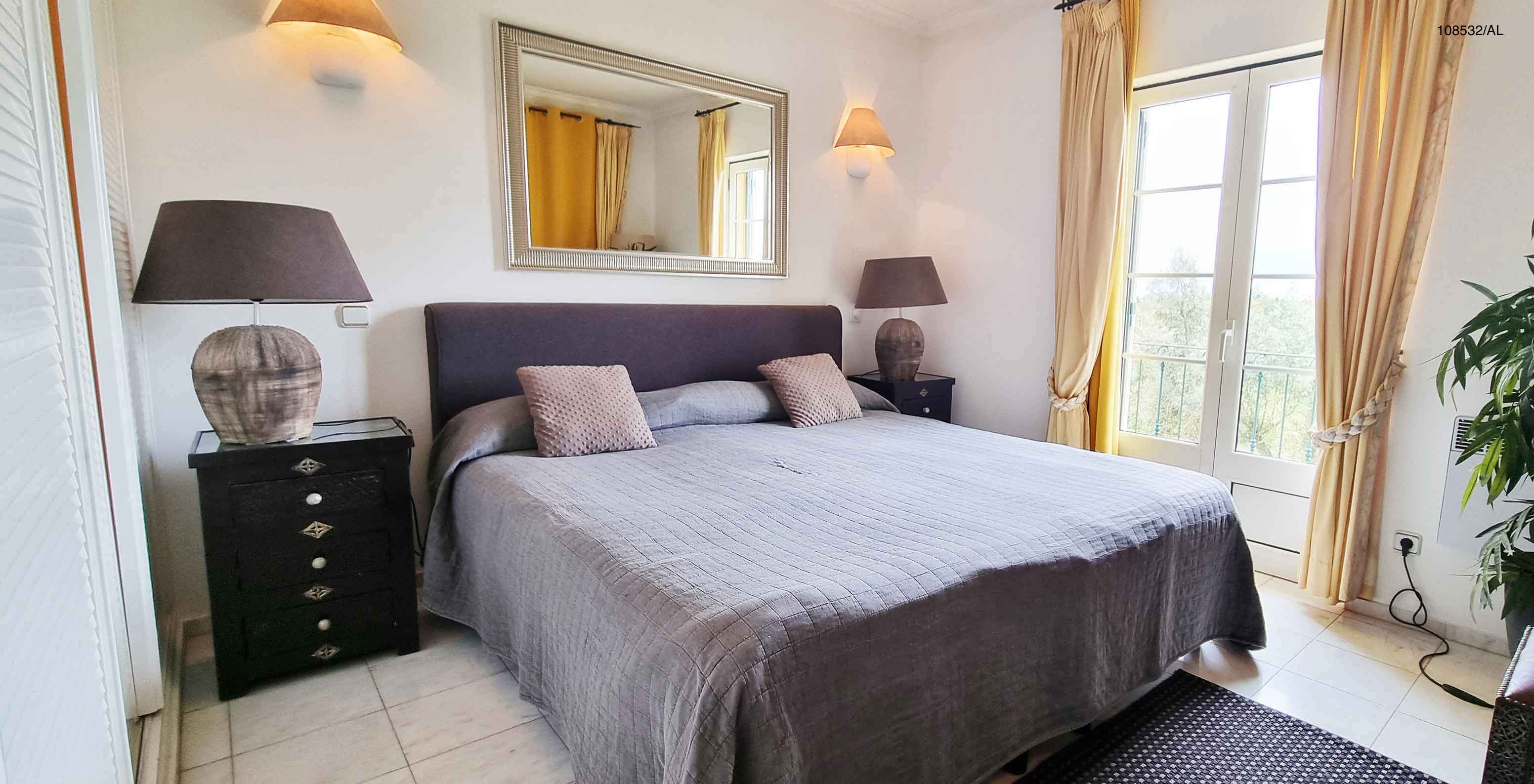 The Pestana Carvoeiro Golf T1 Superior Apartment has a double bed with two nightstands and a mirror