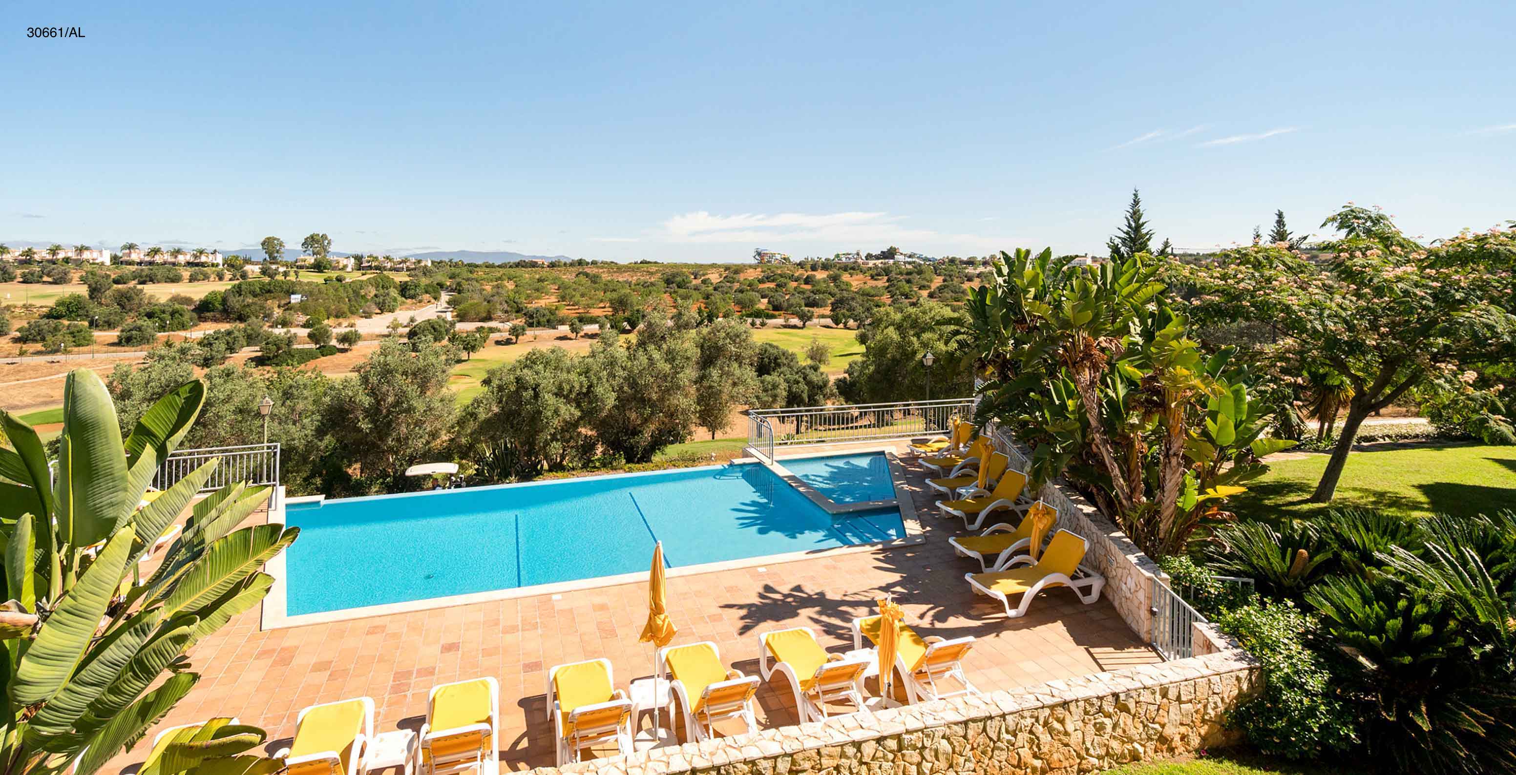 The Pestana Carvoeiro Golf T1 Superior Apartment has an outdoor pool with yellow loungers around it