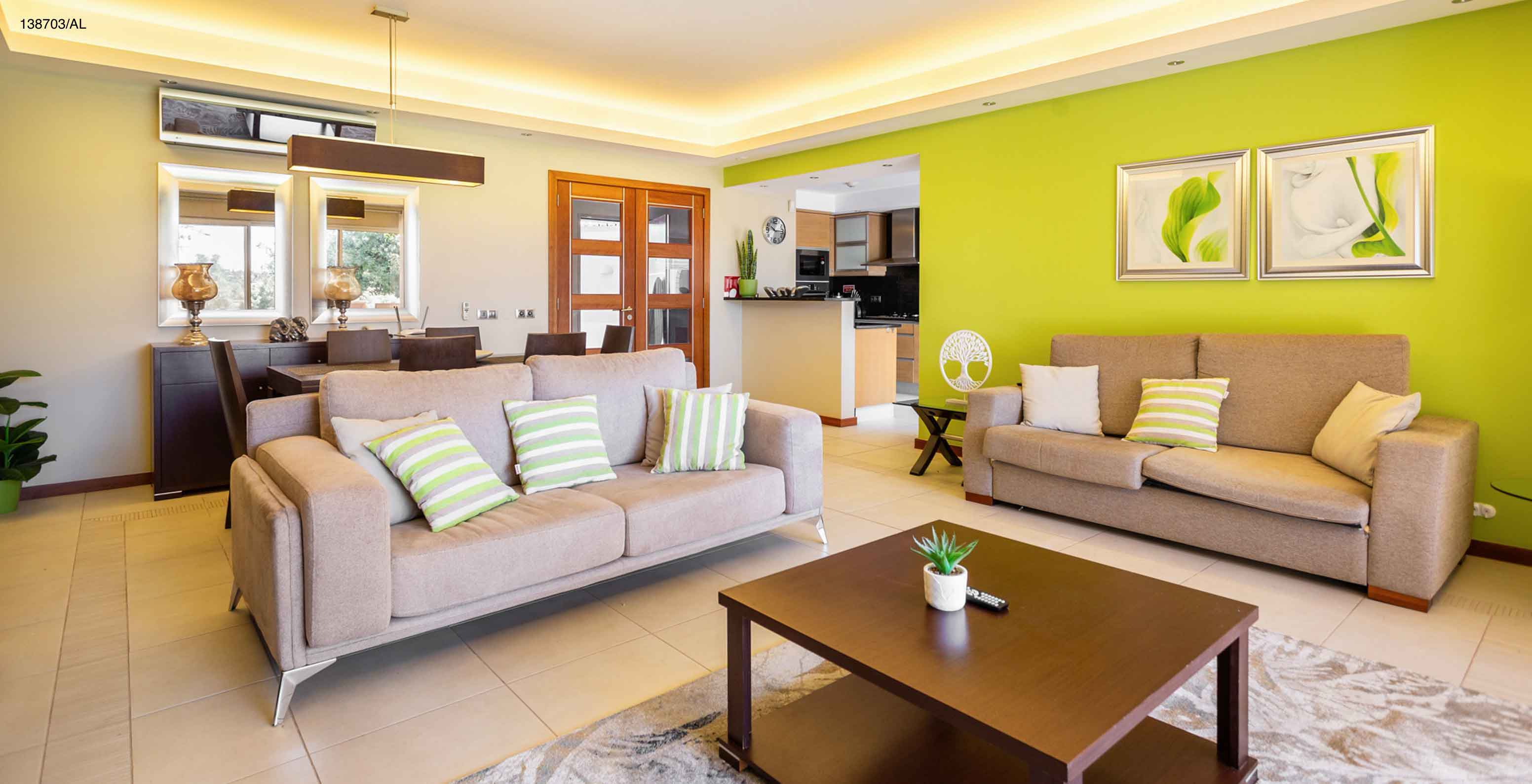 The Pestana Carvoeiro Golf T2 Superior Apartment has a living room with two beige sofas and a coffee table