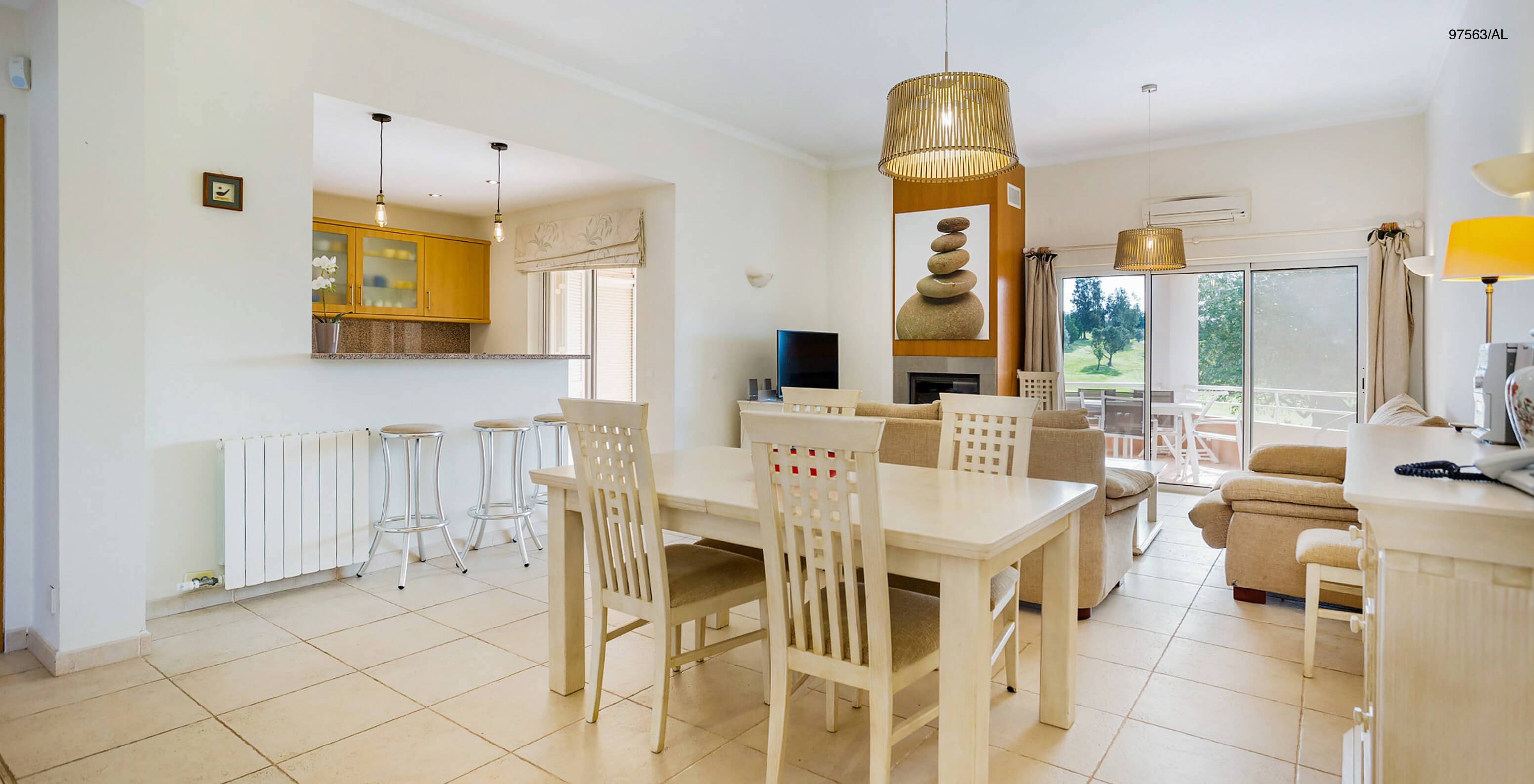 The Pestana Carvoeiro Golf T3 Superior Apartment has a dining room with a view of the kitchen, a table, and four chairs