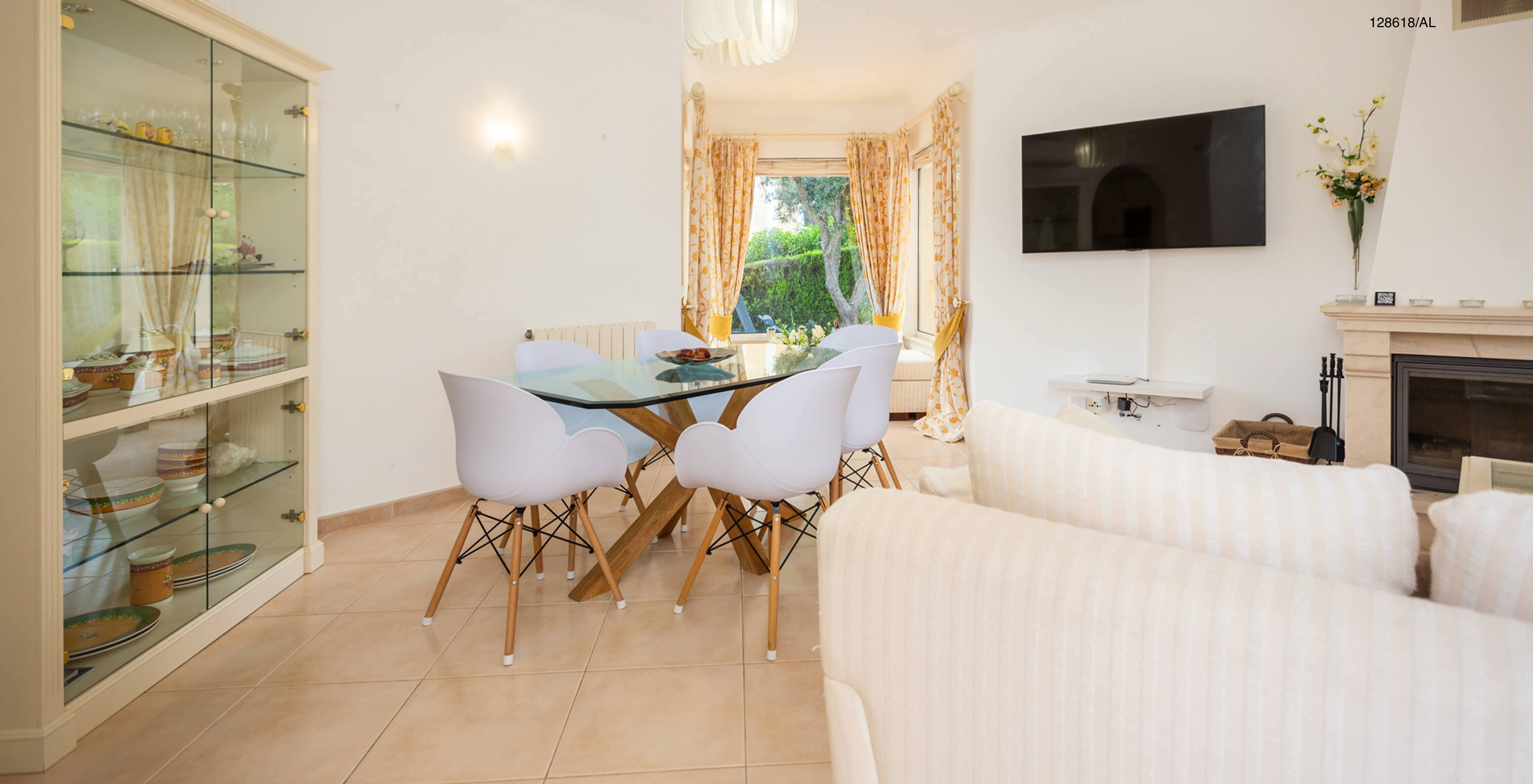 The Pestana Carvoeiro Golf V3 Superior Villa has a living room with a glass table with chairs and a TV