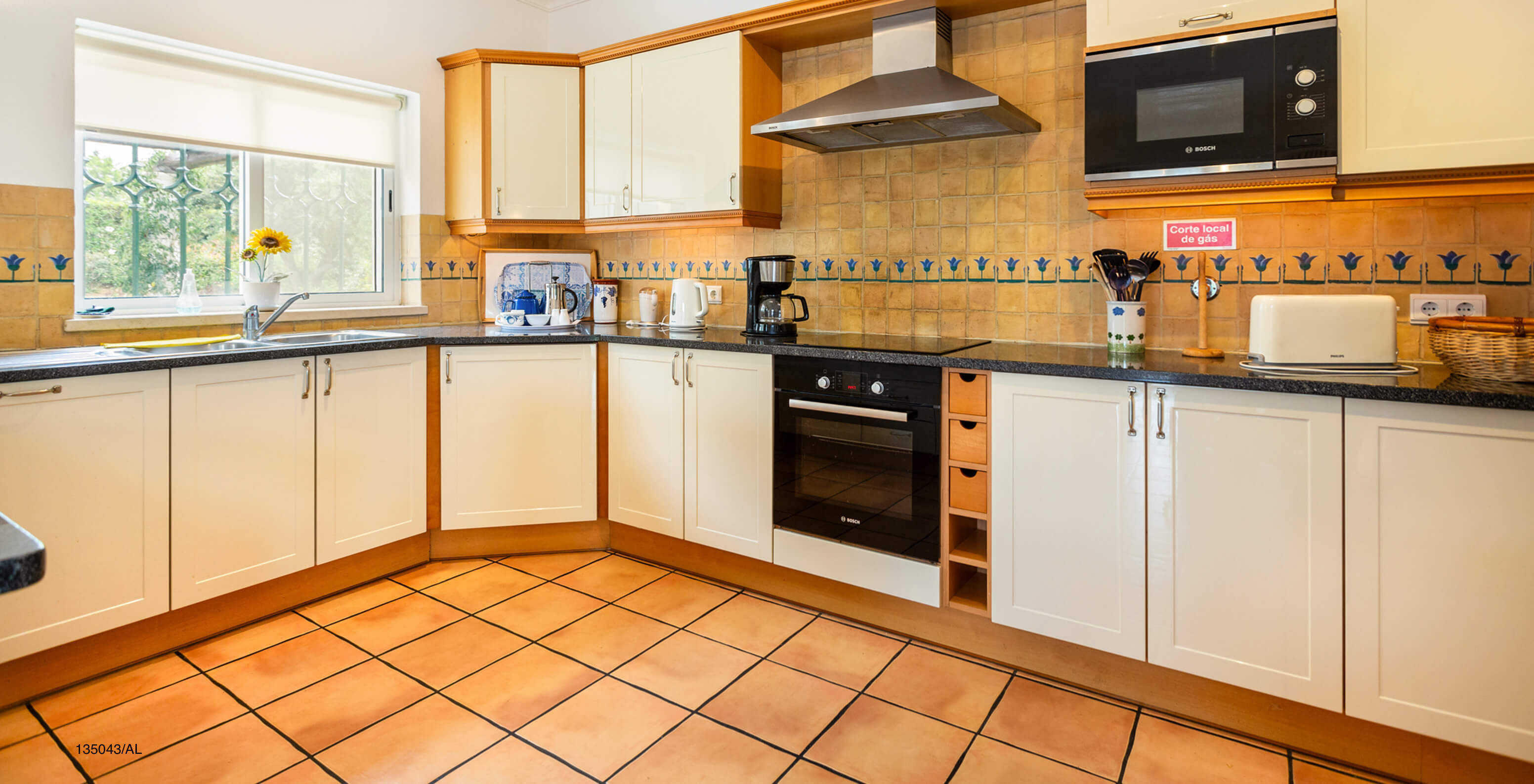 The Pestana Carvoeiro Golf V4 Standard Villa has a kitchen equipped with white cabinets and appliances