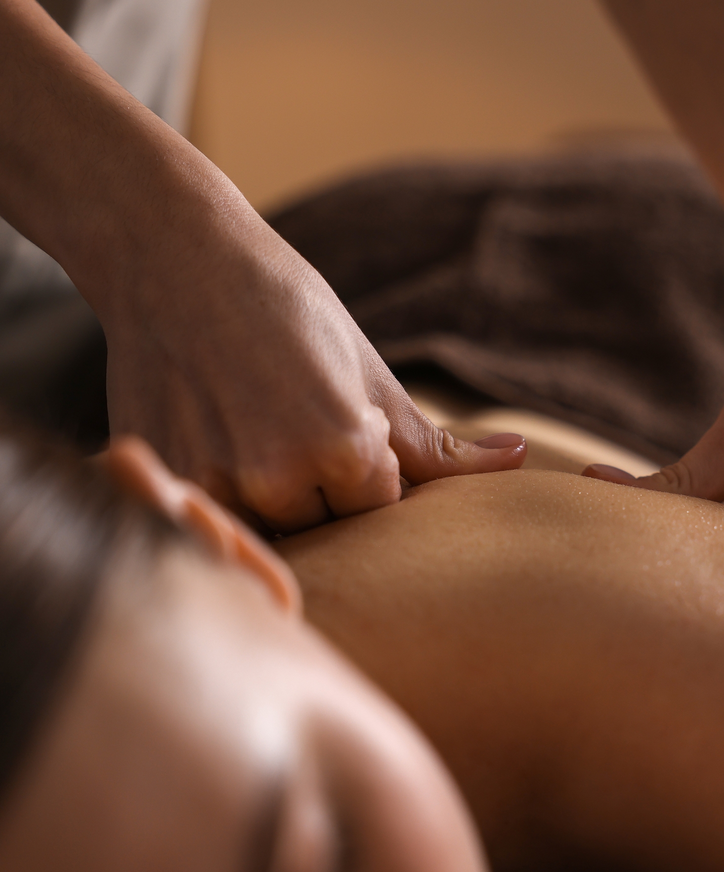 Girl relaxing and receiving a back massage at a hotel with a pool located in a golf course