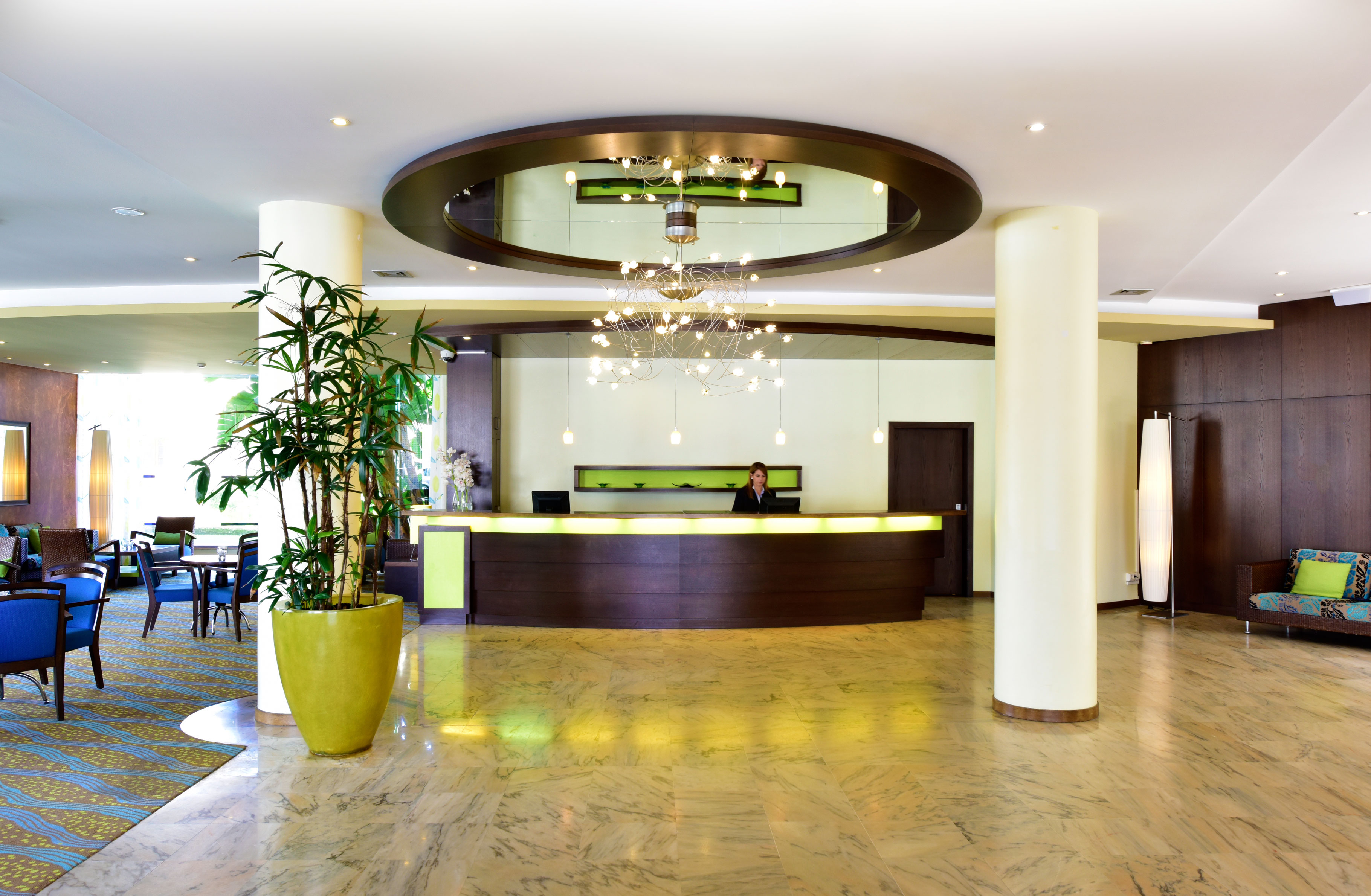 Pestana Viking, a 4-star hotel in Porches, has a reception with a staff member, mosaic floor, and two large pillars