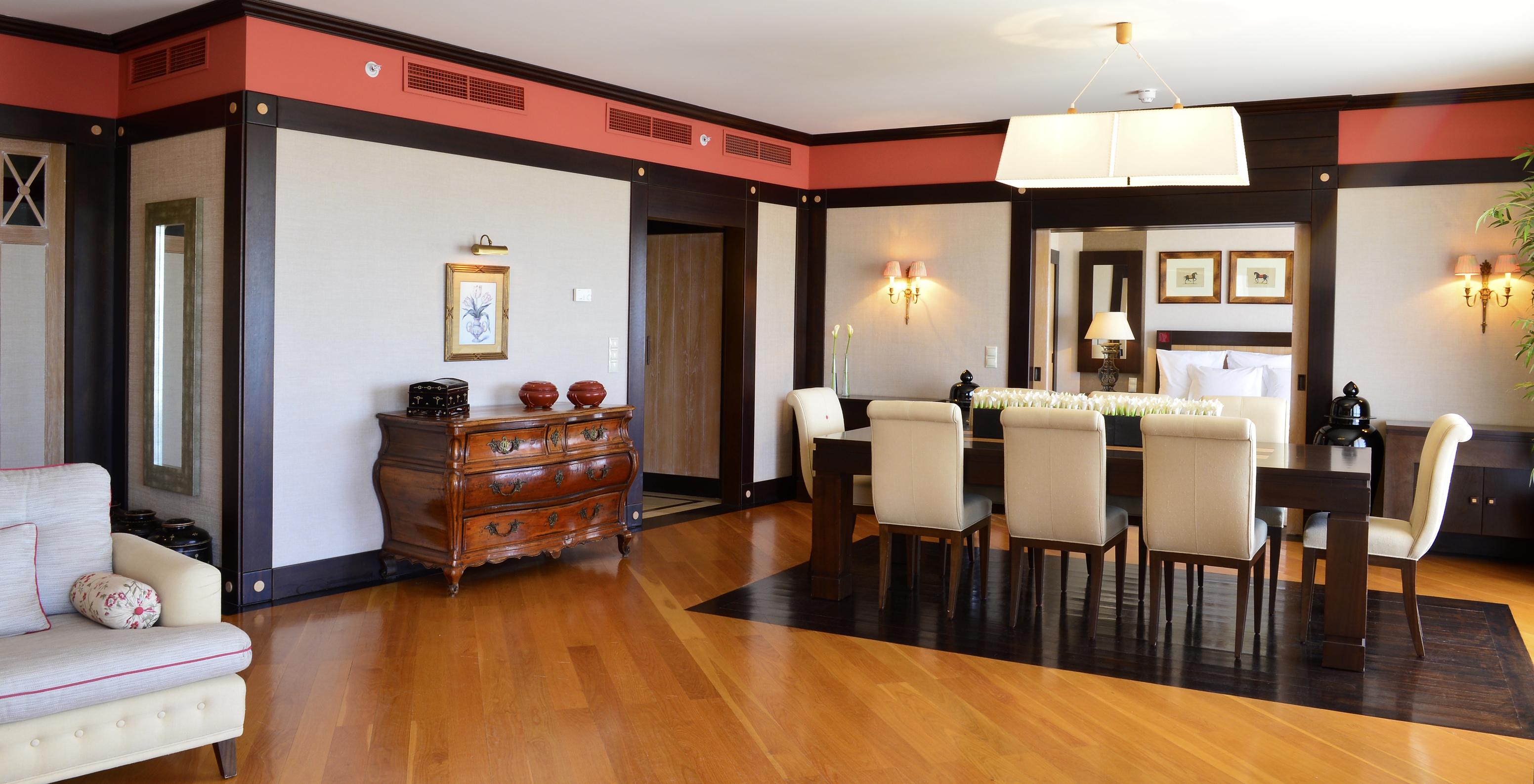 The Presidential Suite at Pestana Vila Sol - Vilamoura has a spacious living room with dining table and wooden sideboard