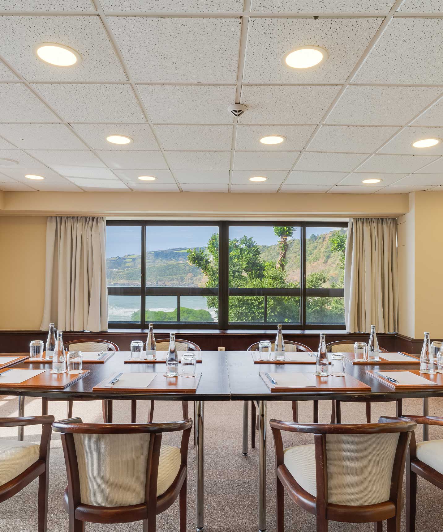 Hotel at São Miguel Island has meeting rooms with tables and chairs set up, sea and nature view